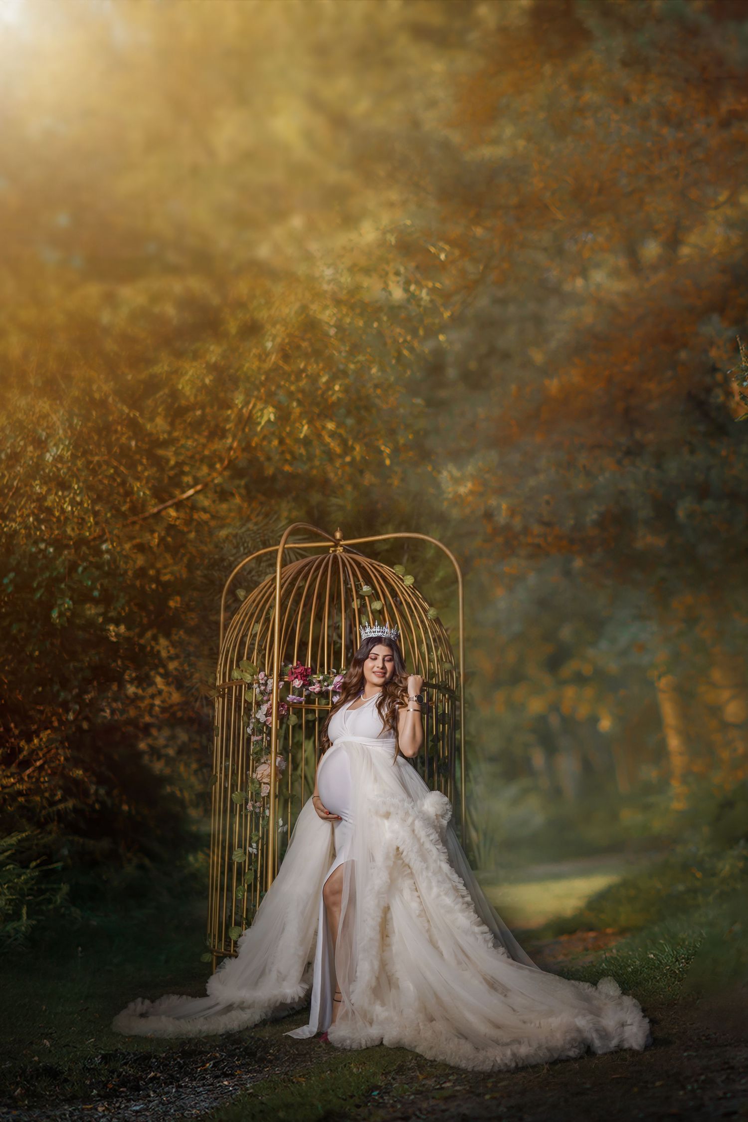 A romantic bridal portrait session with a decorative metal arch and flowing white gown in an autumn setting.