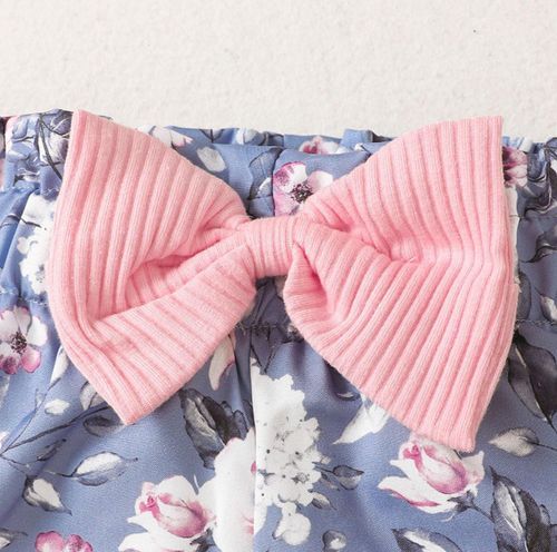 Pink corduroy fabric bows arranged in a row showing texture and design details.