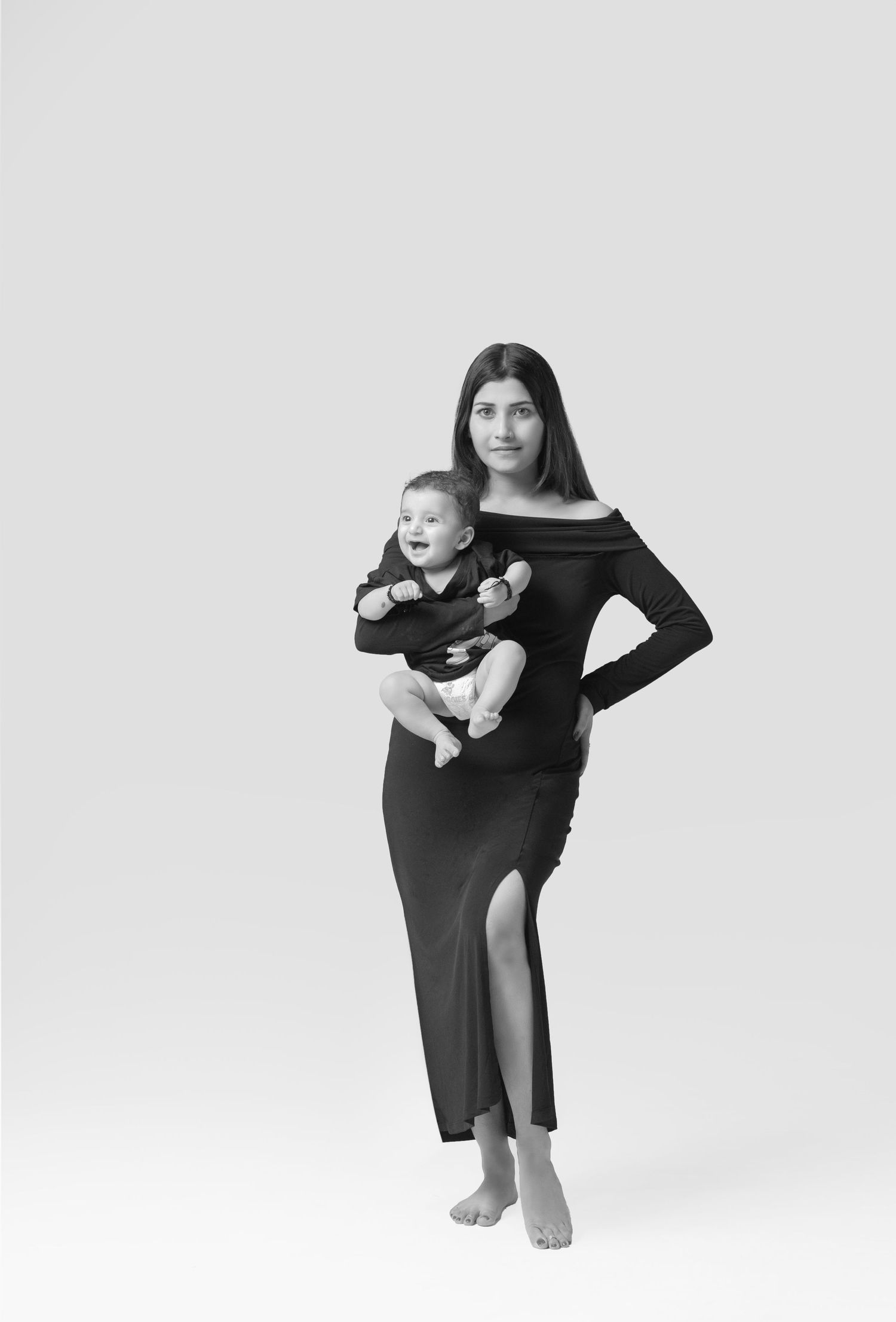 A minimalist black and white photo series capturing motherhood moments in artistic poses.
