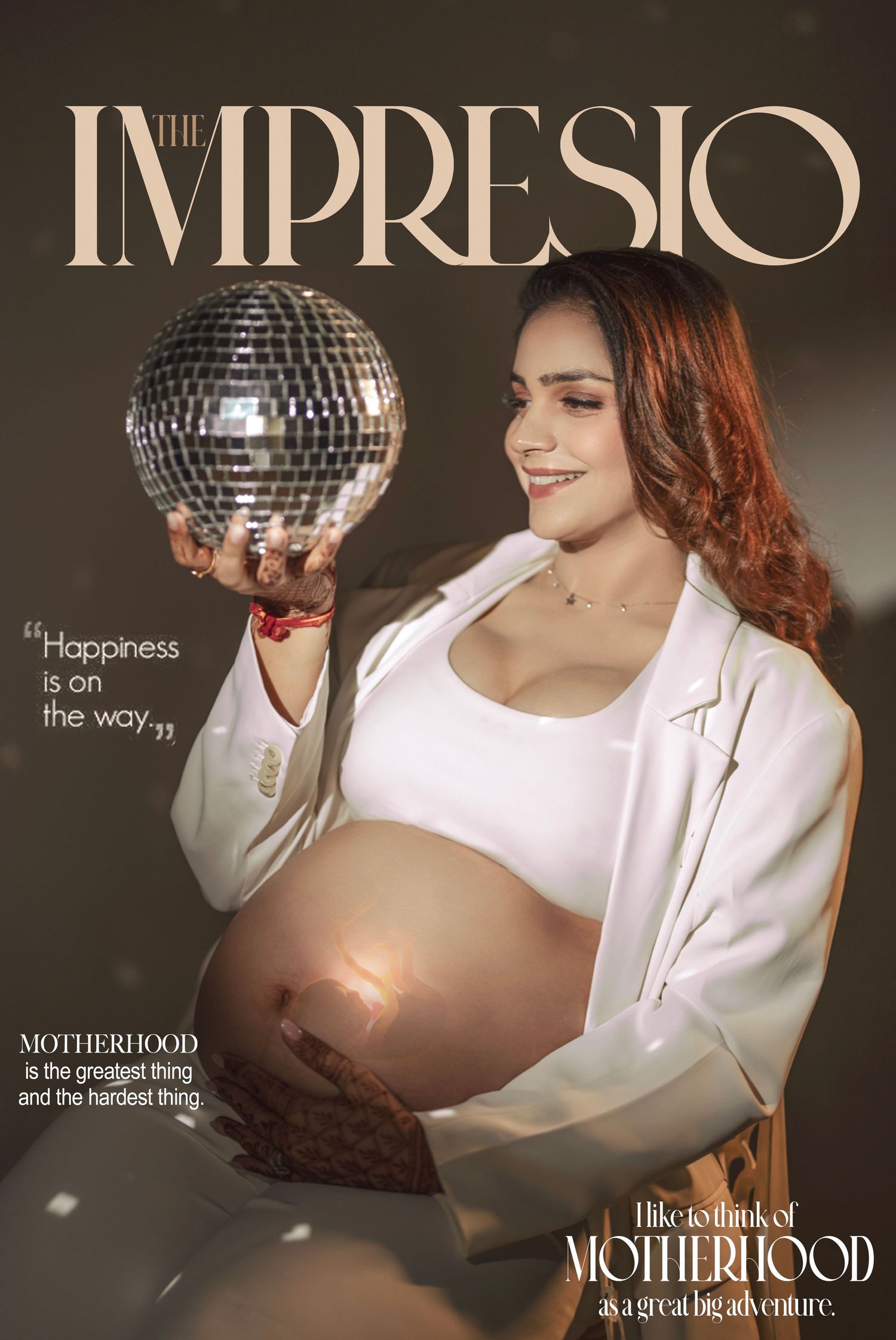 Disco-themed maternity photography with disco ball and white outfit against grey backdrop.