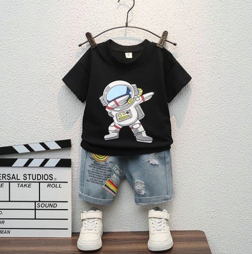 Black t-shirt with astronaut print paired with distressed denim shorts and white sneakers.
