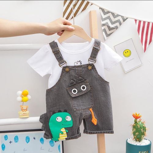 White t-shirt and gray denim overalls set with cute dinosaur plush accessory.