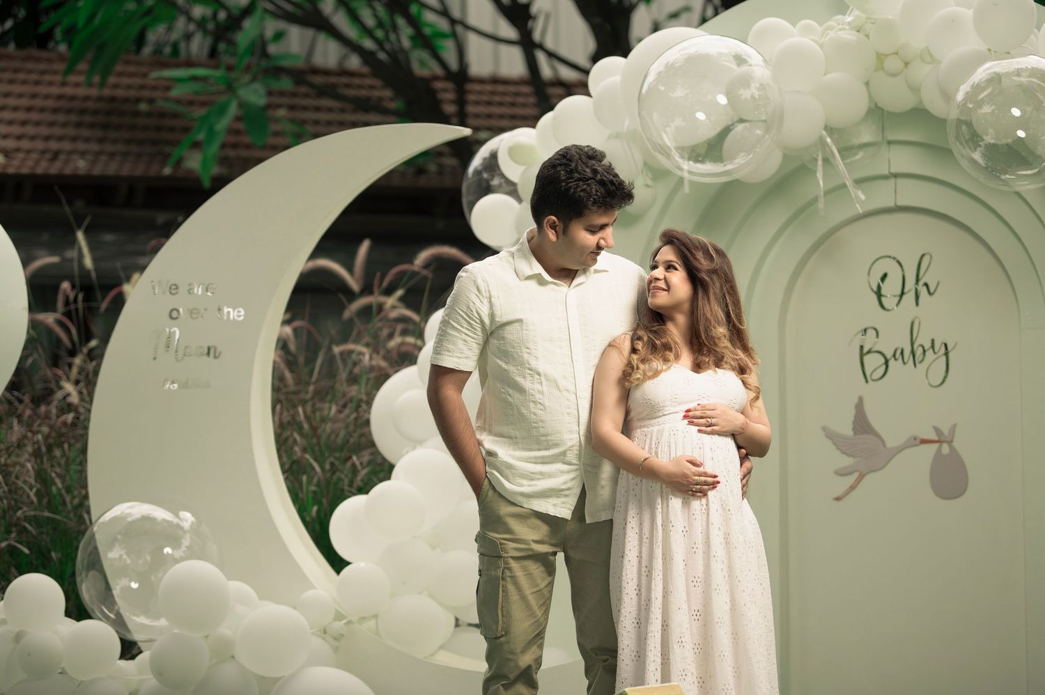 Baby shower photography poses with floral umbrella and ethnic wear – Impresio Studio