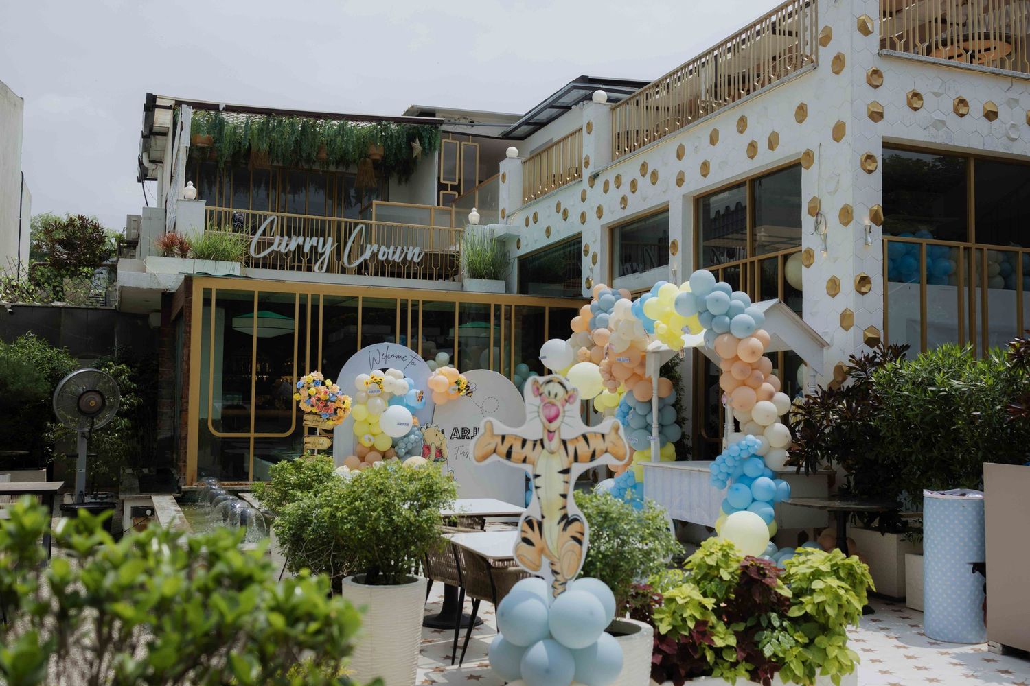 Curry Crown restaurant exterior decorated with colorful balloons and festive party decor for a special celebration event.