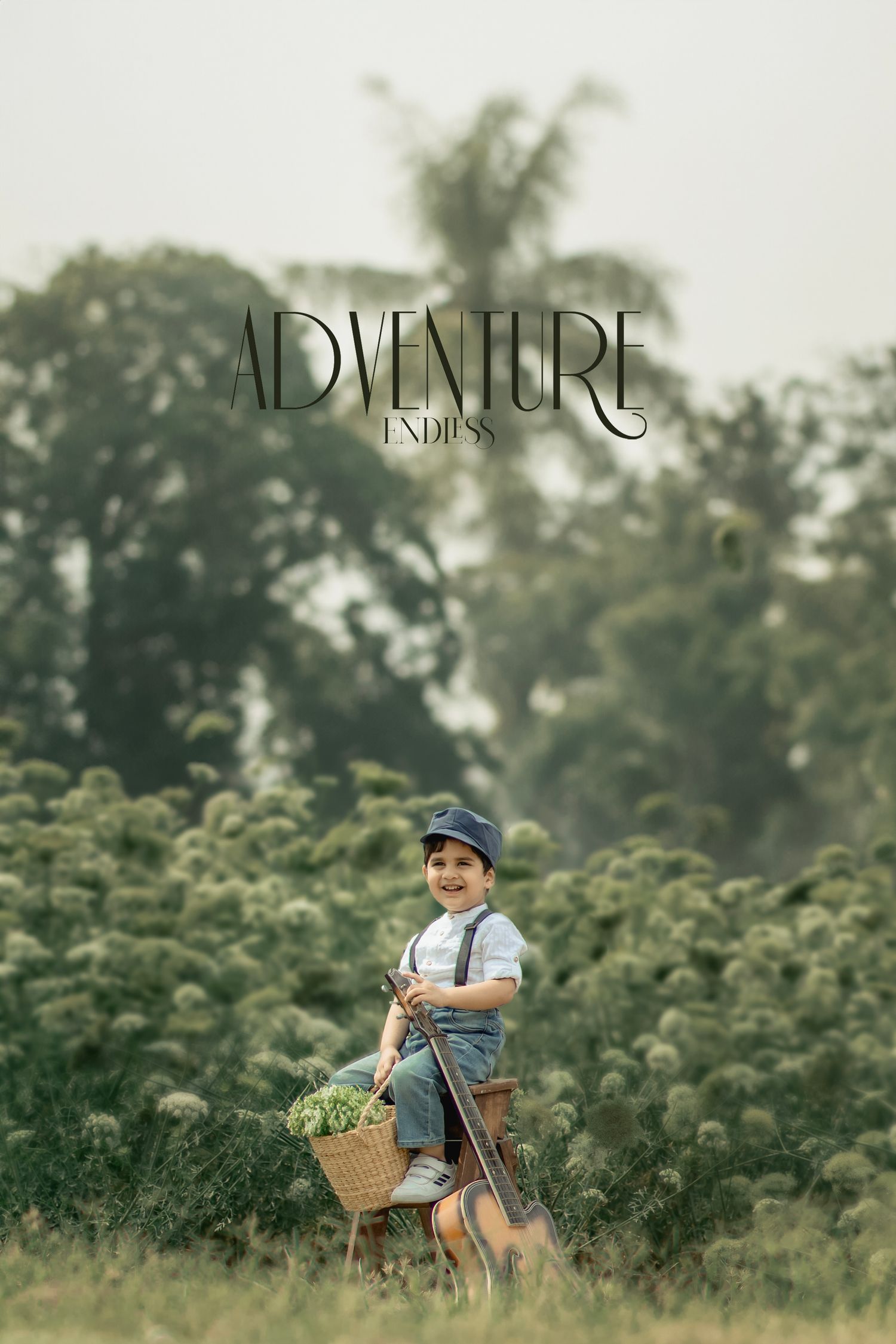 A cheerful young boy in suspenders and a hat sits outdoors in a lush green field with a basket of flowers.