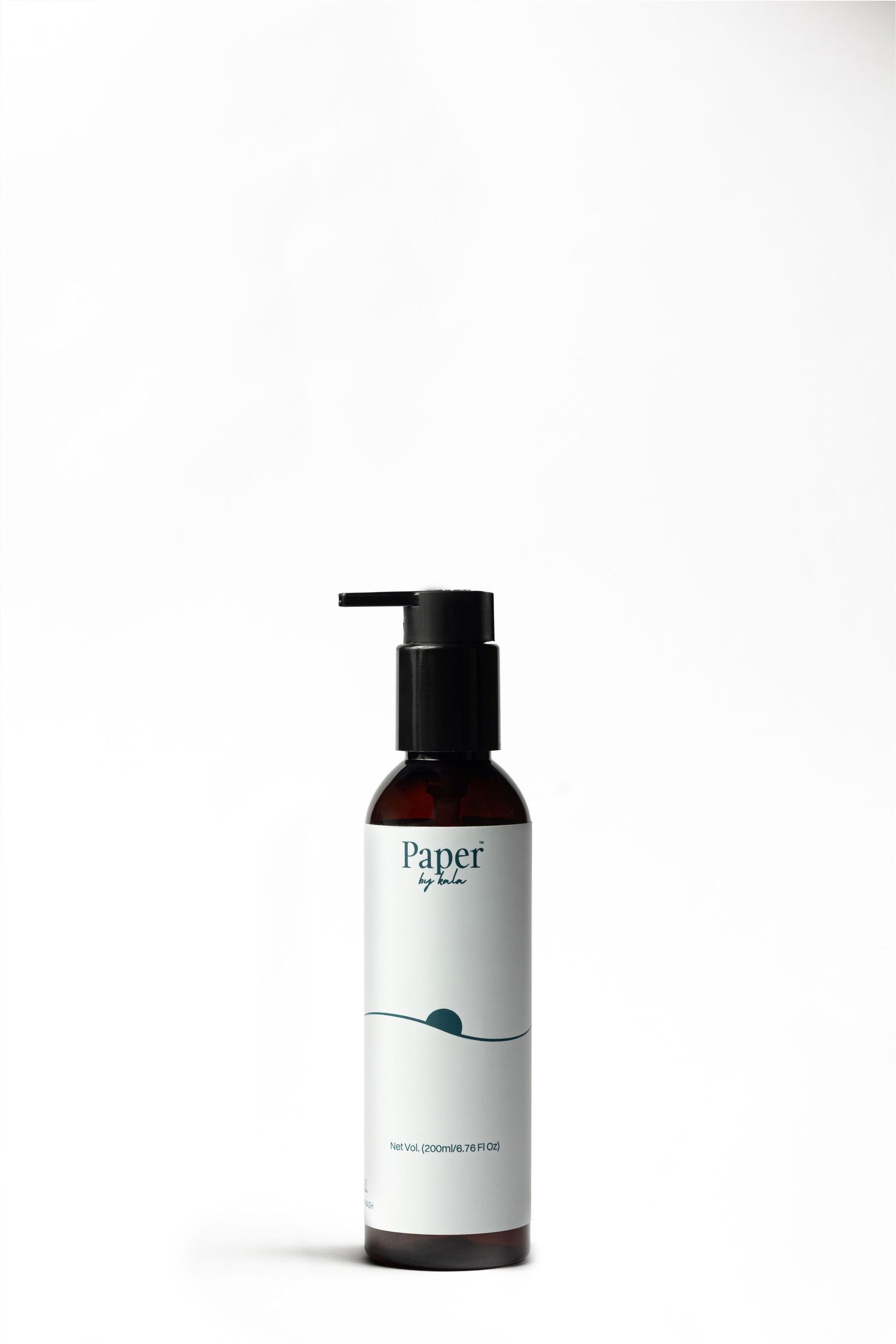 Paper by Lola natural cleansing bath oil in an amber bottle with black pump dispenser and minimalist white label with blue wave design.