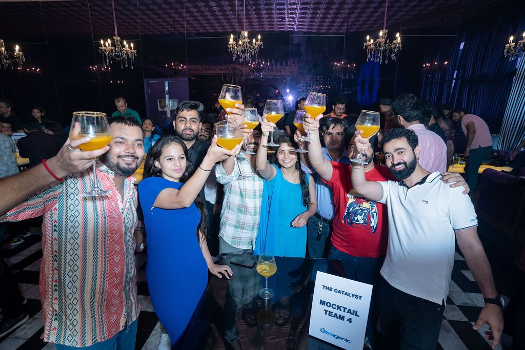 Group of friends toasting with cocktails at a nightclub party, smiling and celebrating together.