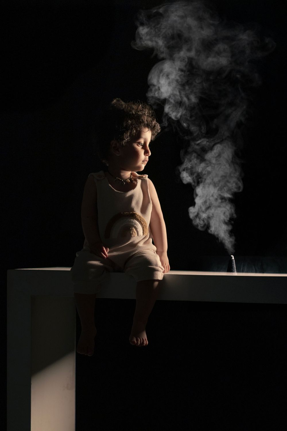 Artistic black and white photograph with dramatic lighting and smoke effects.