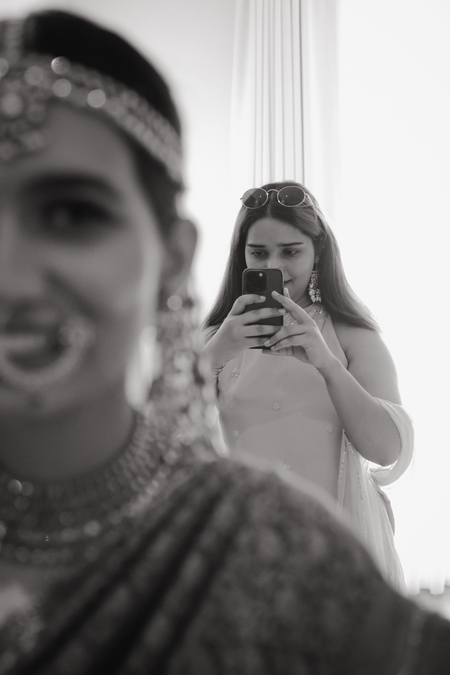 Black and white collage of wedding photos showing candid moments through a camera lens.