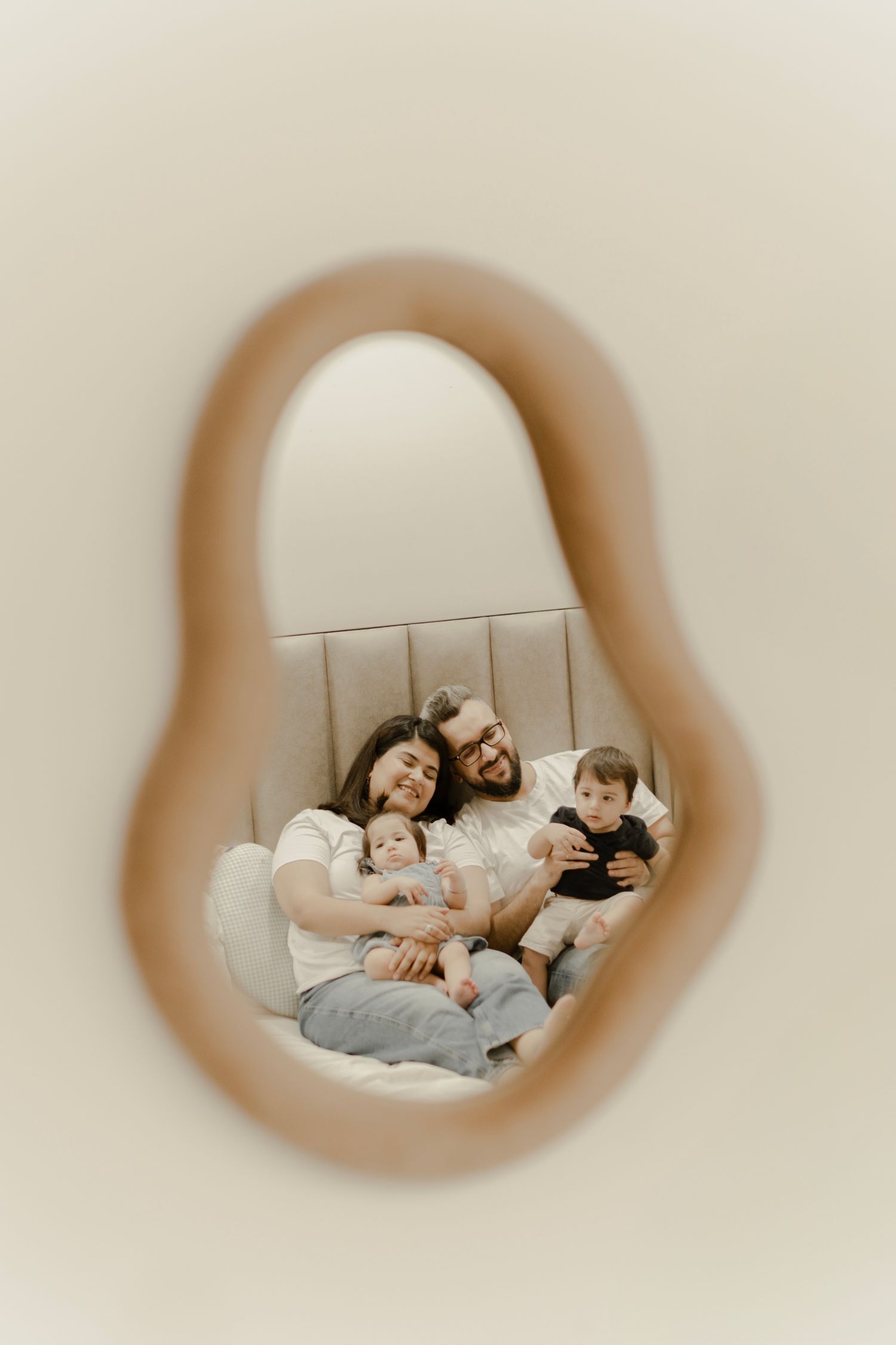 Series of circular peephole views showing people resting together on a couch through a progressively blurred lens effect.