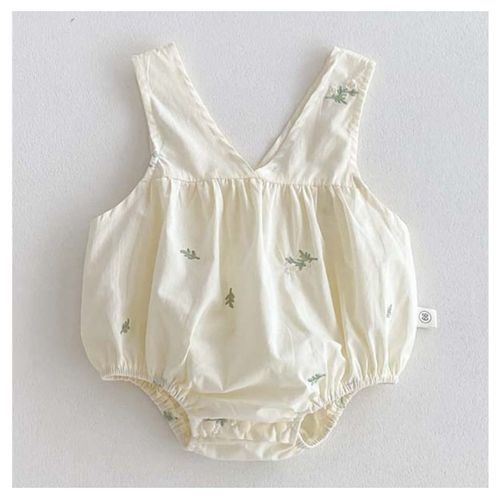 Cream-colored baby romper with delicate floral embroidery and shoulder straps.