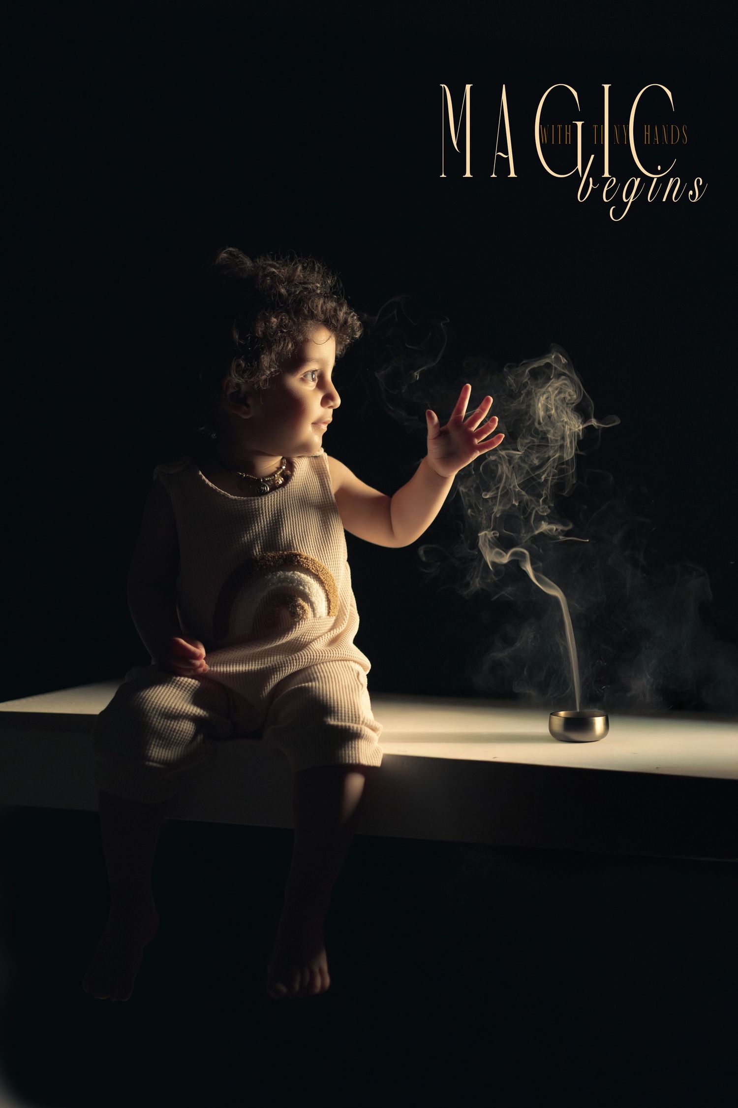 A young child sits in dramatic lighting, reaching toward rising smoke from a small vessel, with text reading Magic Begins.