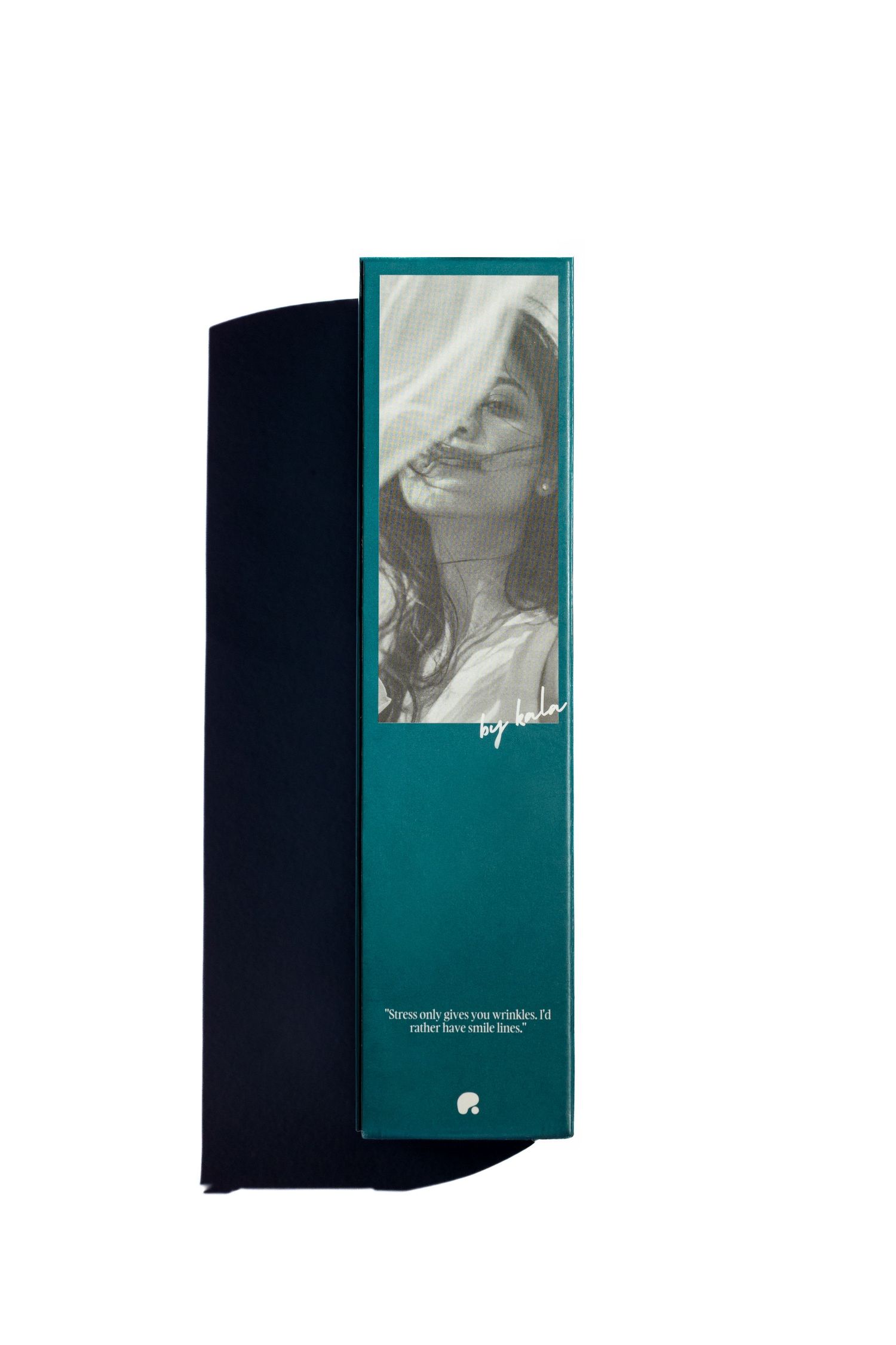 Teal gift box with a black-and-white portrait of a smiling woman with windblown hair and a handwritten quote about smile lines.