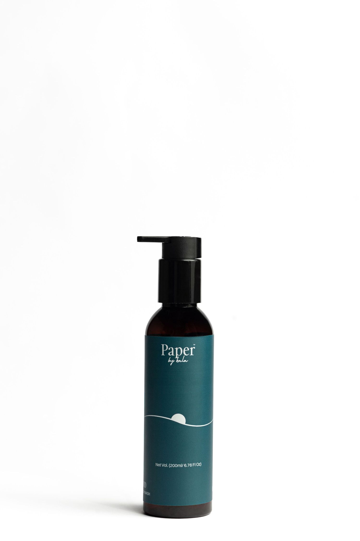 Dark amber pump bottle with teal Paper by Lola label featuring a minimalist wave and sun design, photographed on a white background.