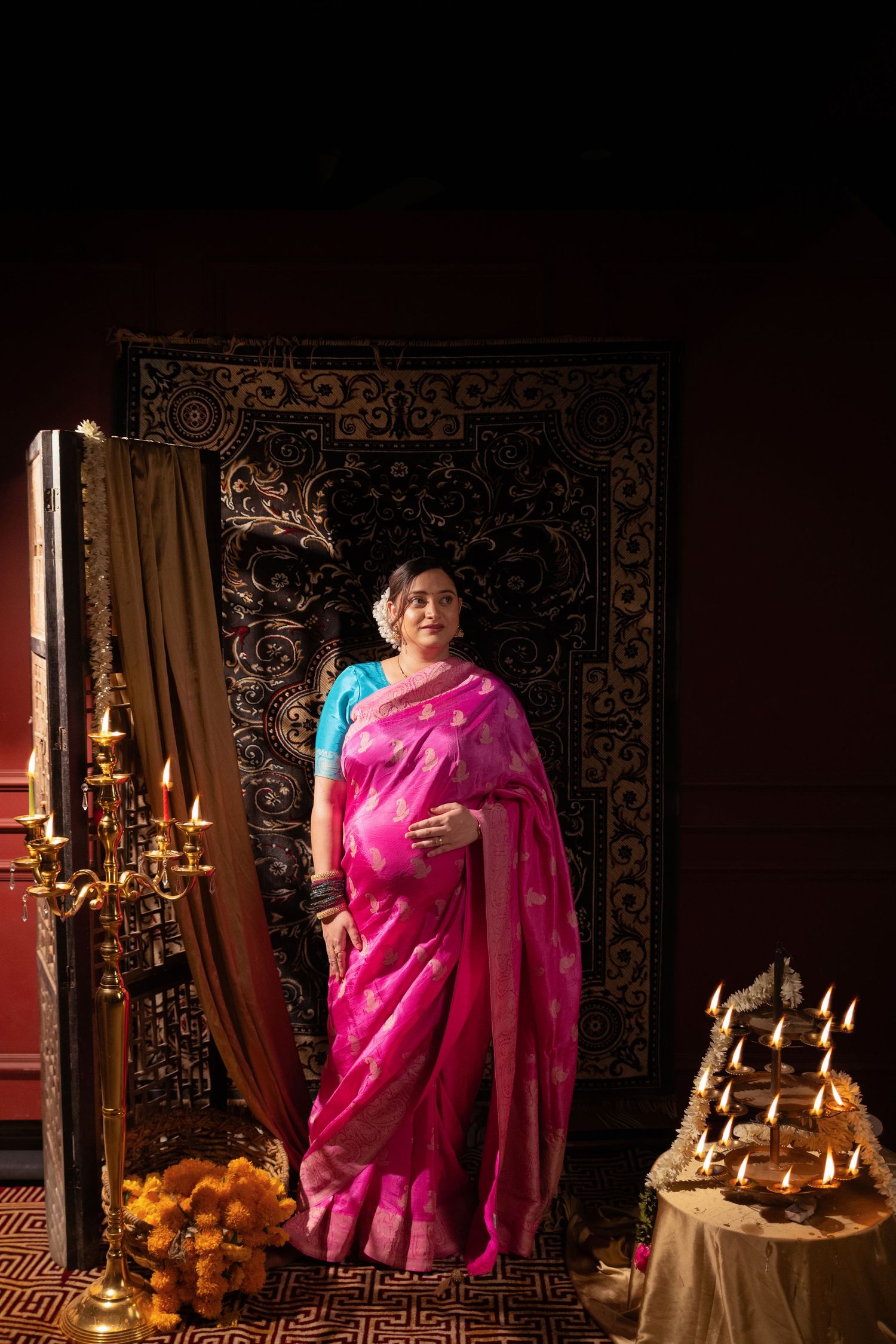 A series of five photos showing a traditional Indian setting with candlelit decorations and a person in a vibrant pink sari.