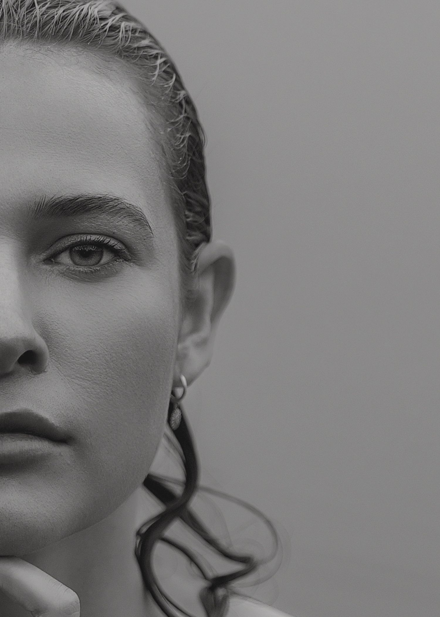 Dramatic black and white portrait series showing artistic close-up angles.