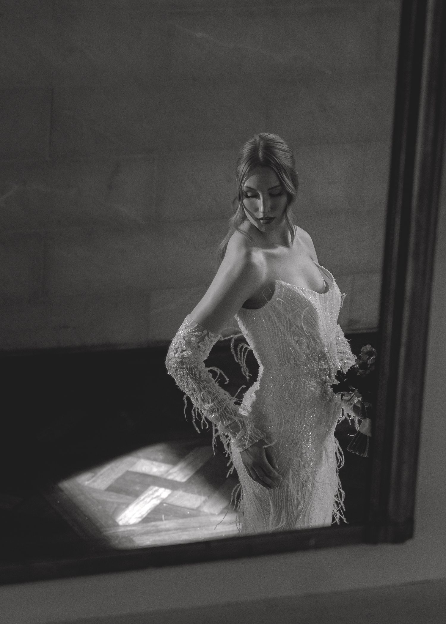A series of black and white photos showing a figure in a white wedding dress through a window frame.