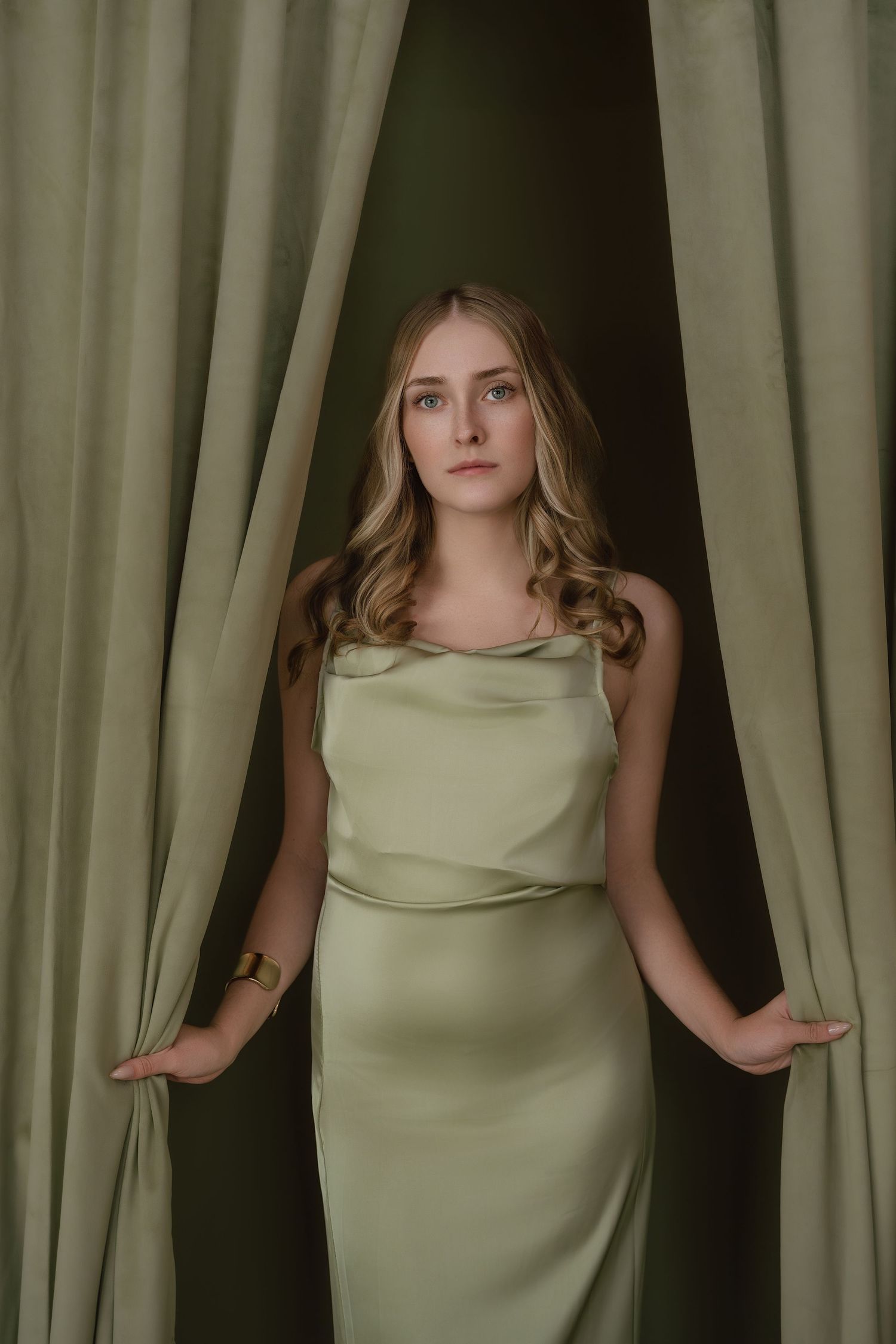 A series of photos showing a person in a light green sleeveless dress posing against a backdrop of curtains.