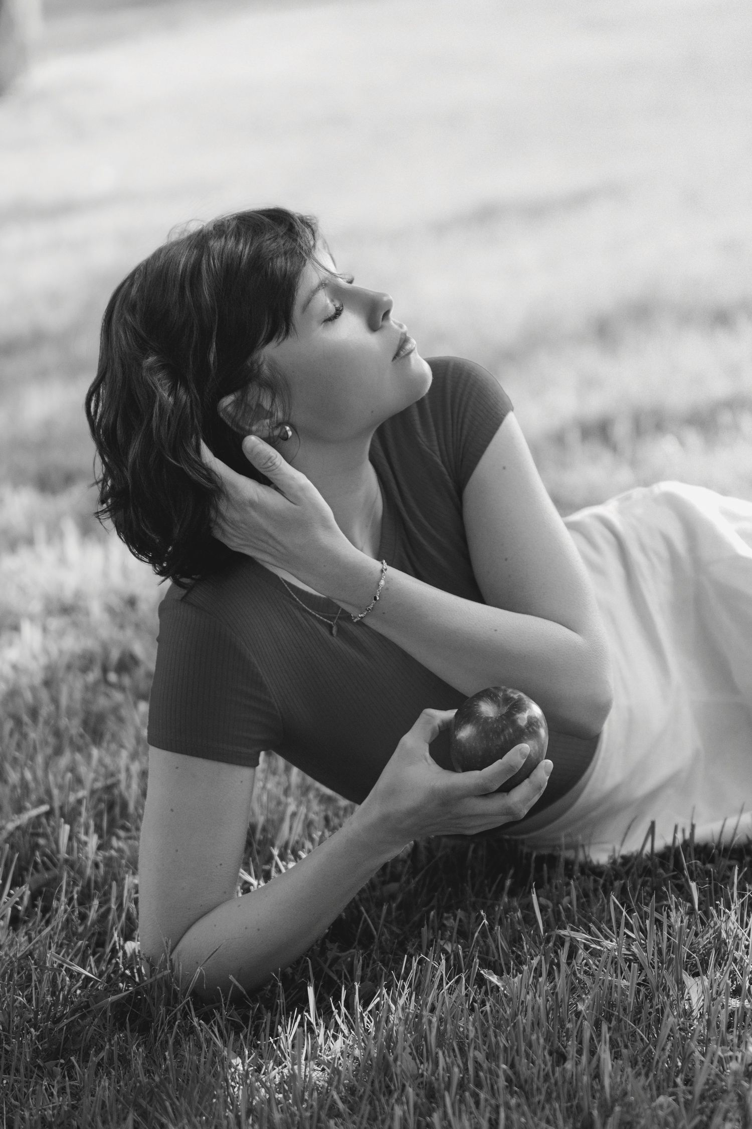 A series of black and white photos showing someone reclining peacefully in tall grass while listening to music.
