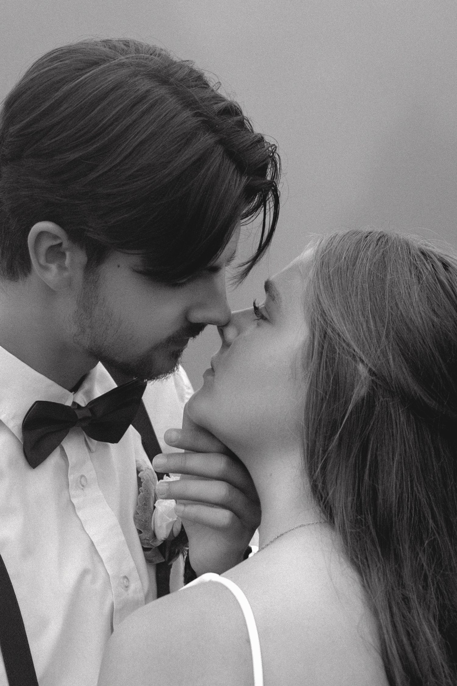 Series of romantic black and white photos showing a tender intimate moment between partners in white shirts.