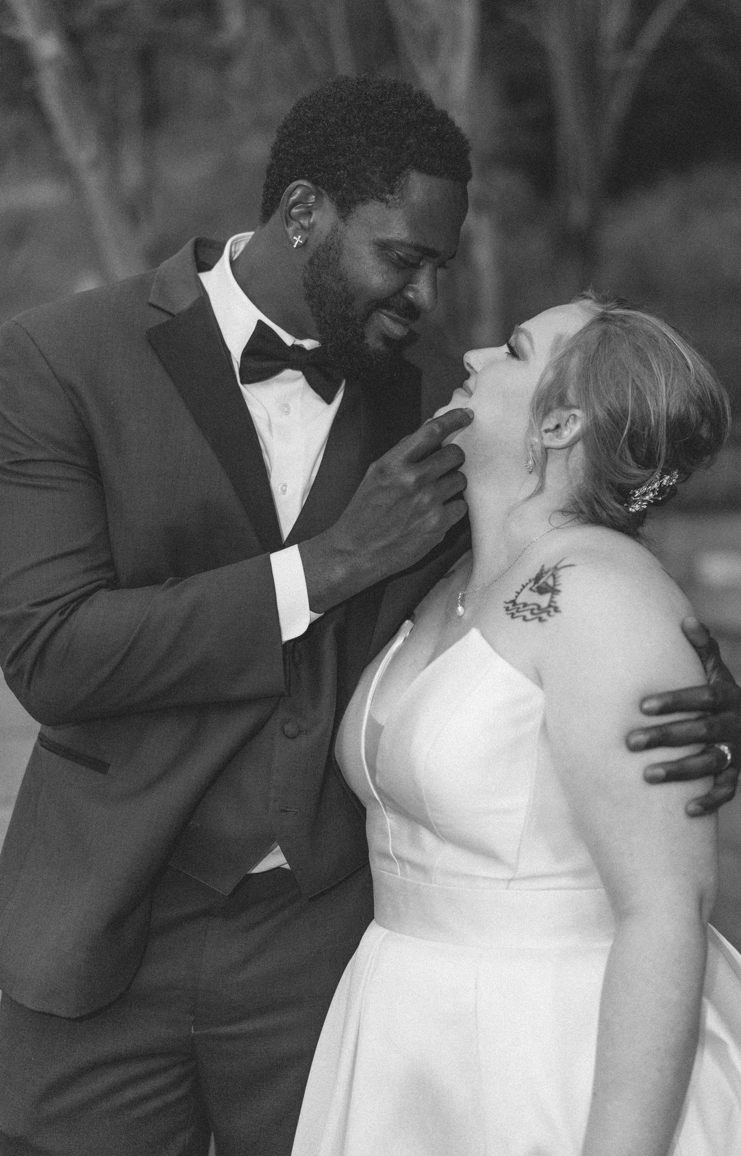A joyful wedding couple sharing an intimate moment during their outdoor celebration.