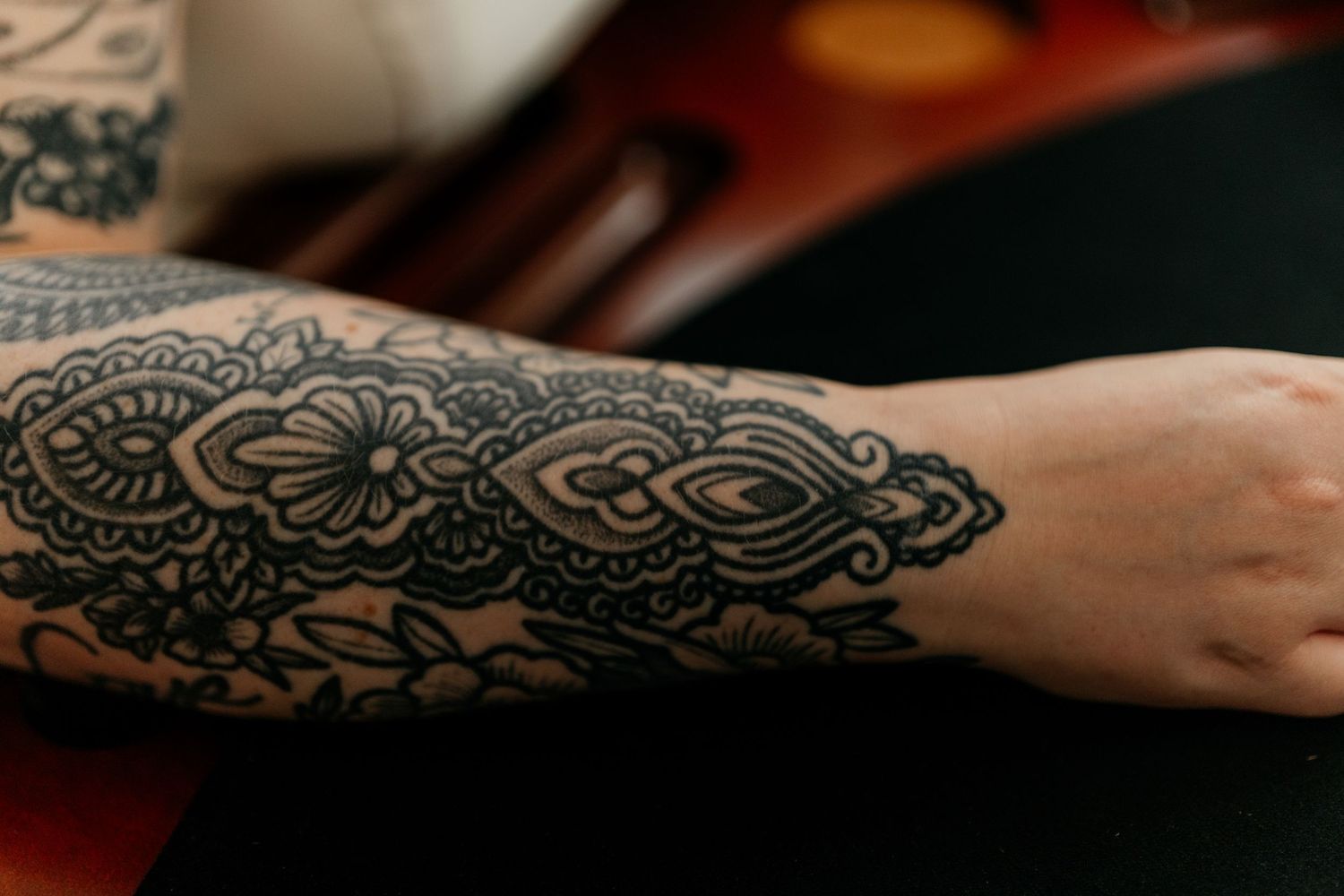 Intricate henna designs adorning hands against a dark background.