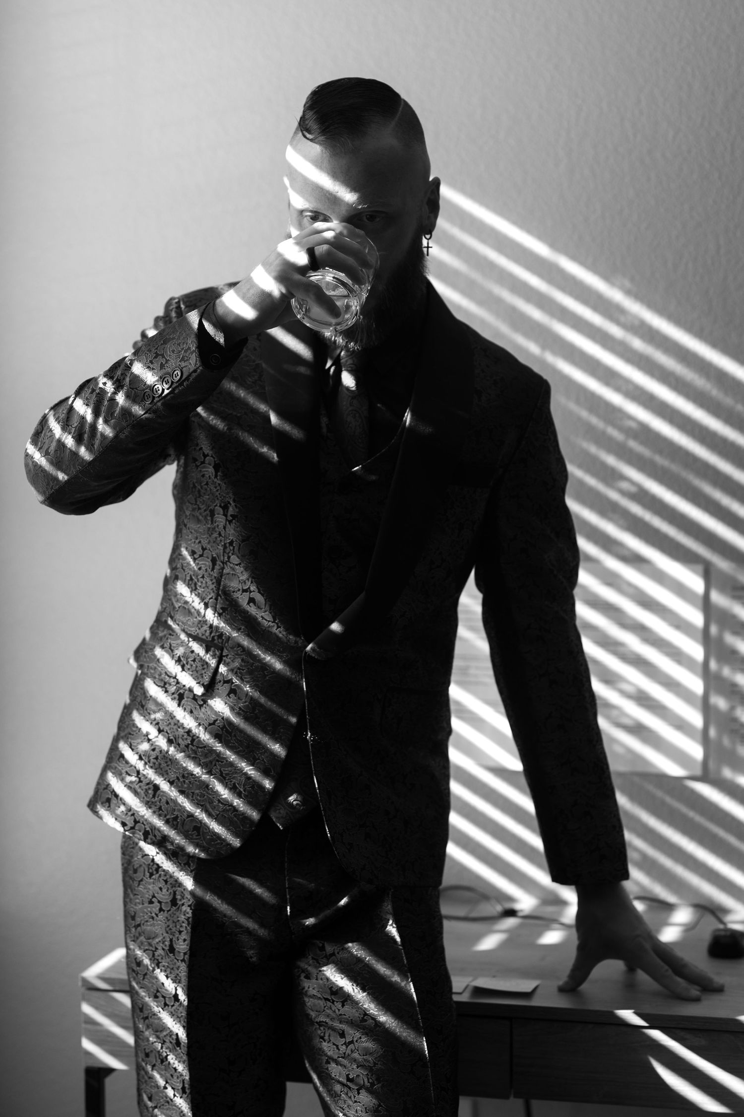 Black and white artistic photo series showing dramatic shadows cast by window blinds across a person in dark clothing.