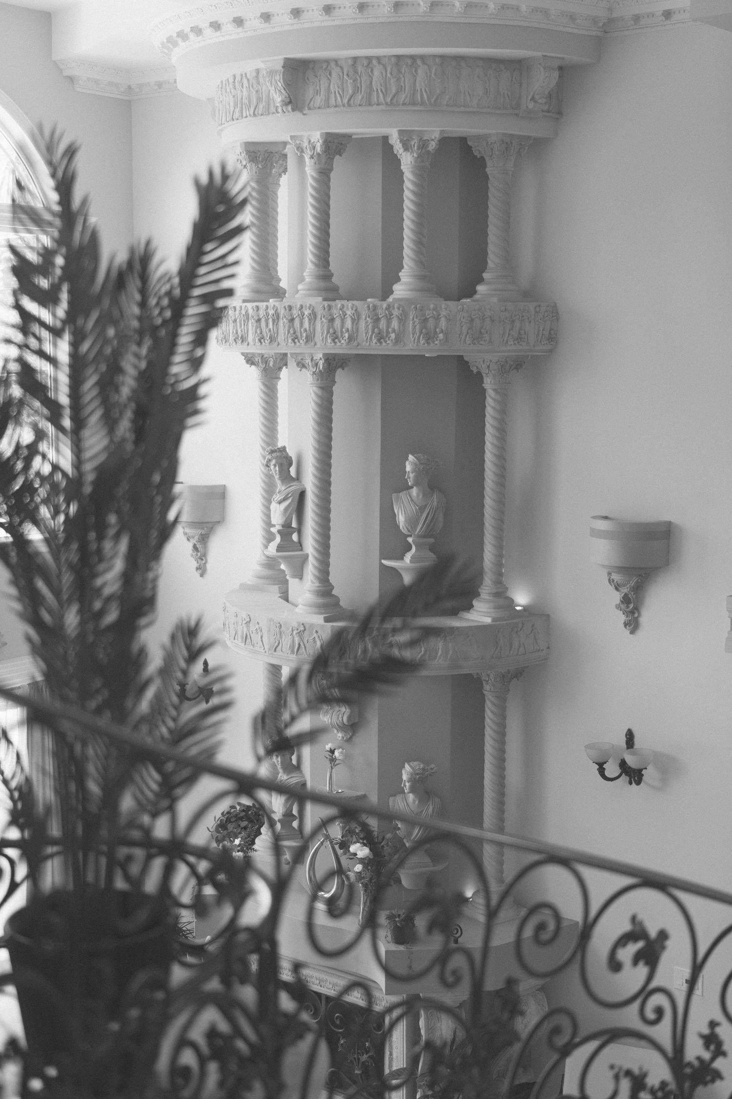 Ornate white architectural details with decorative moldings and columns against a wall.