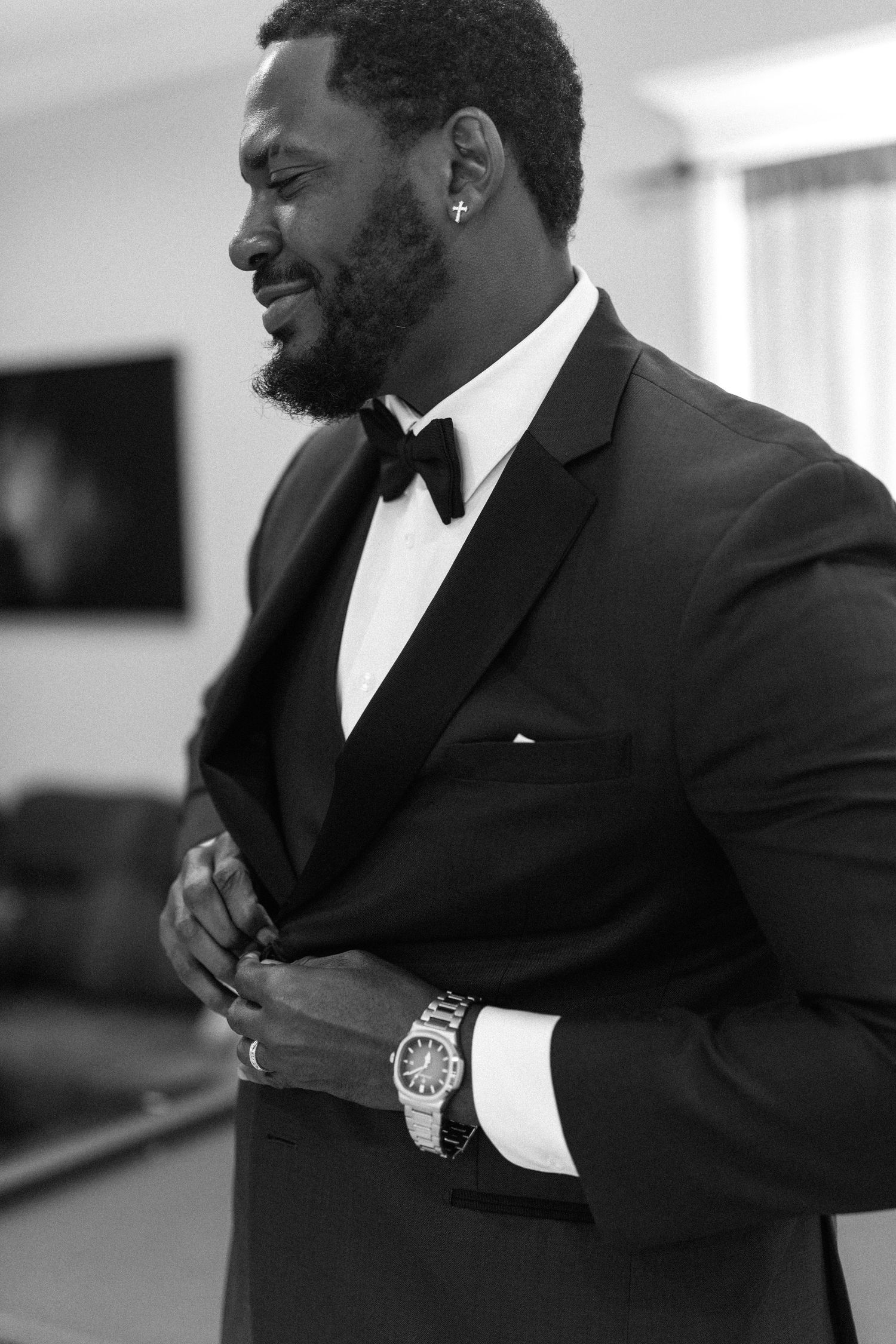 A groom in a black suit adjusting his cuffs in a series of black and white photographs.