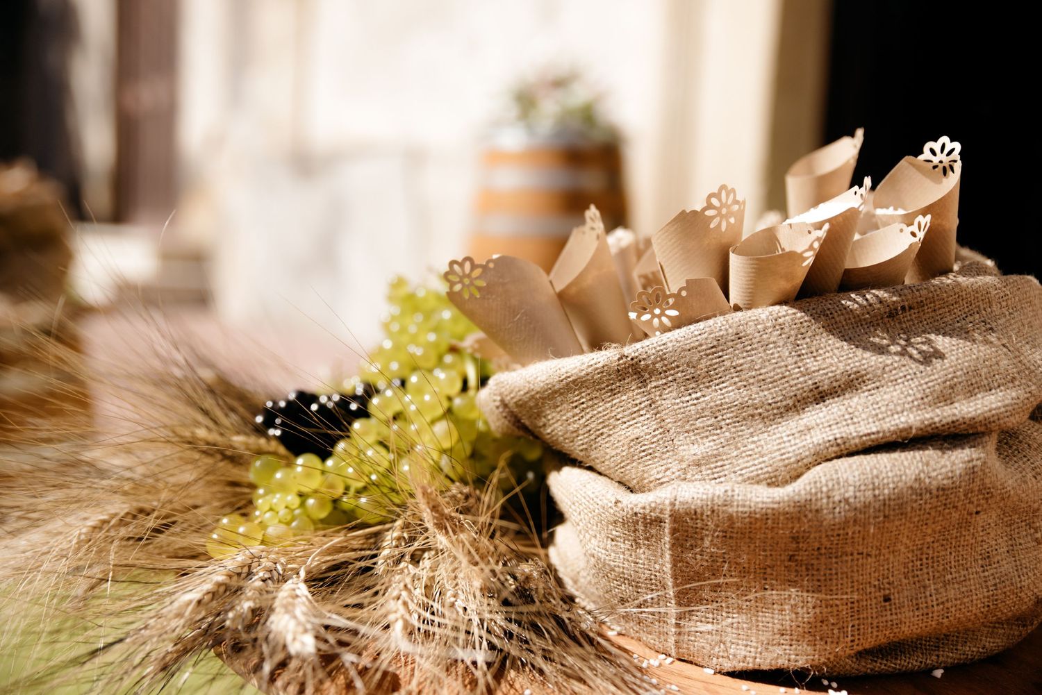 Fresh baked artisanal bread loaves displayed on rustic wooden surface with wheat stalks and natural lighting.