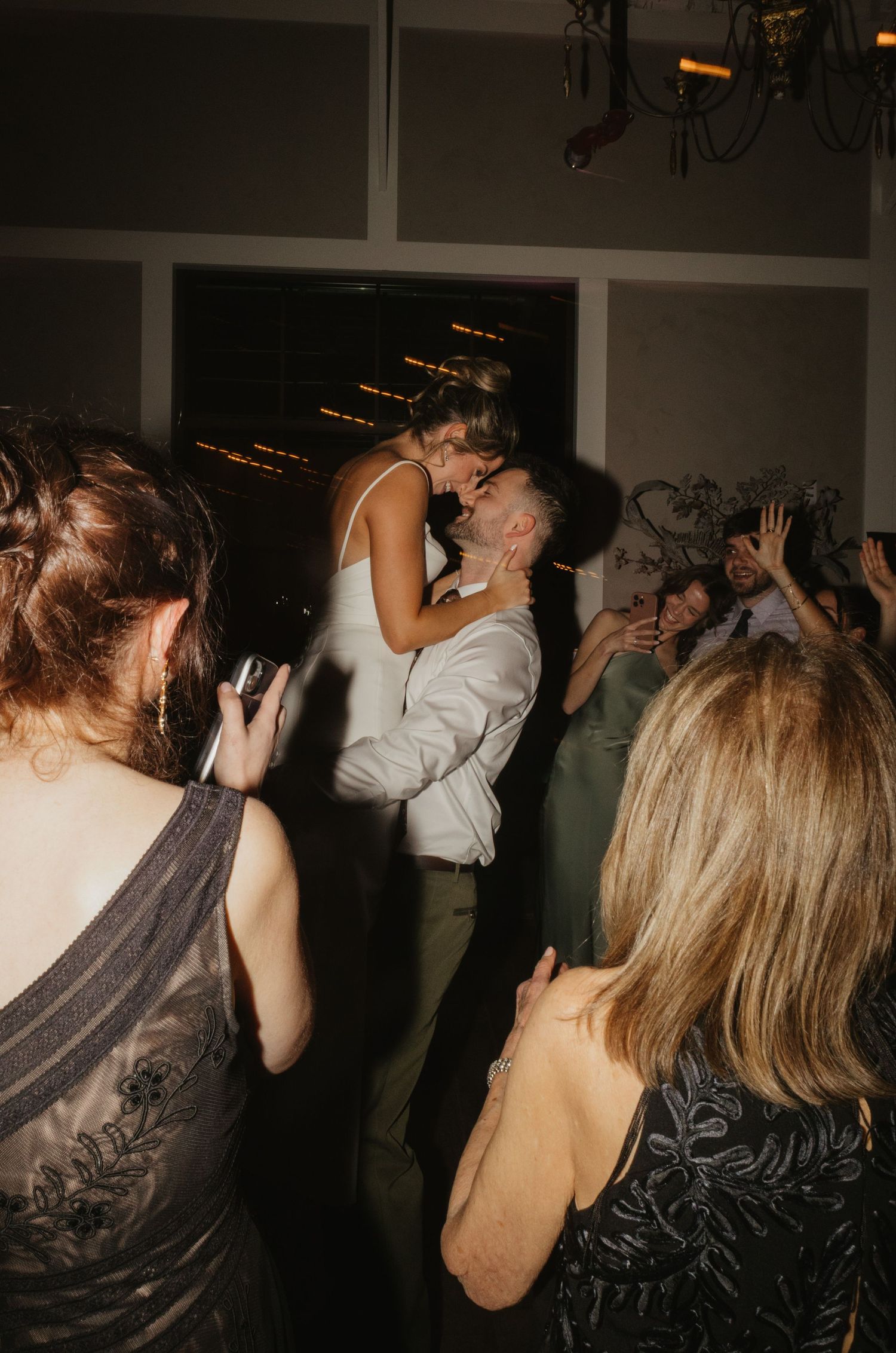 A series of blurry party photos showing people dancing and celebrating in a dimly lit room.
