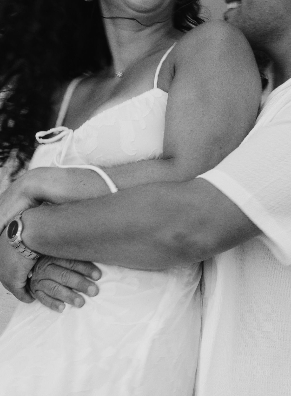 A black and white artistic photo series showing intimate close-up details of entwined arms and hands.