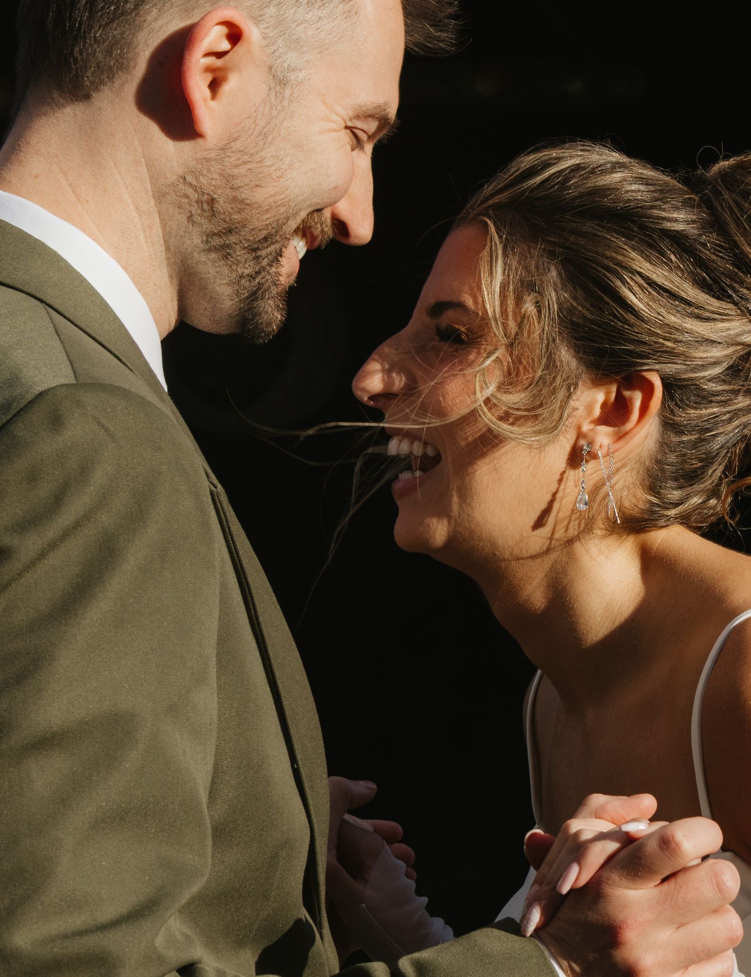 A romantic wedding couple shares an intimate moment during their photo session at sunset.