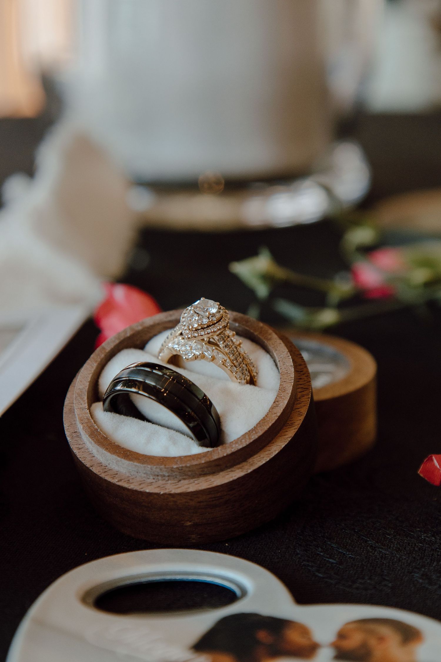 Wedding rings nestled in a wooden box with elegant cushioning.