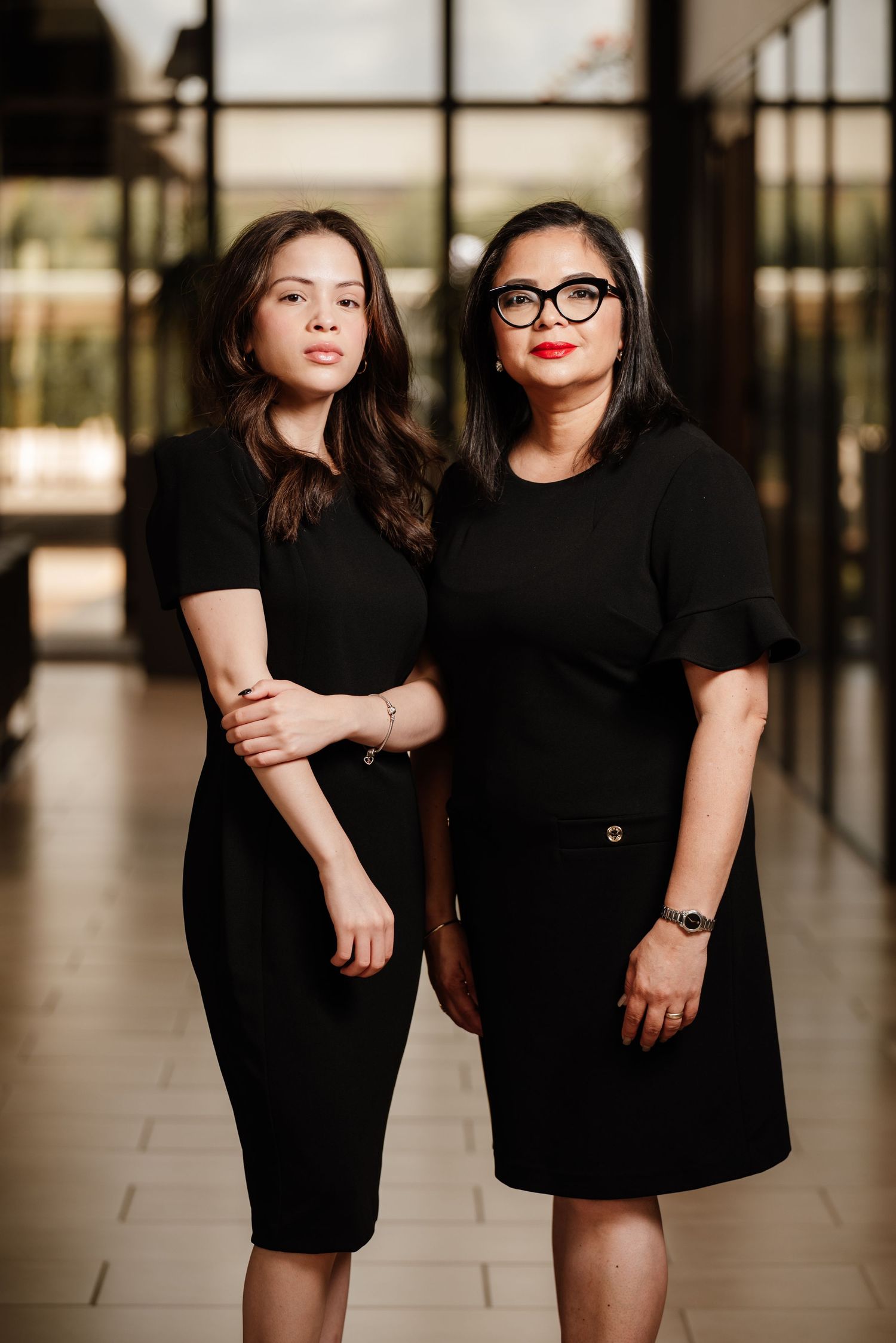 Portrait of two immigration law professionals taken in the lobby of their Houston, Texas office. On-location photo with flash lighting, idea