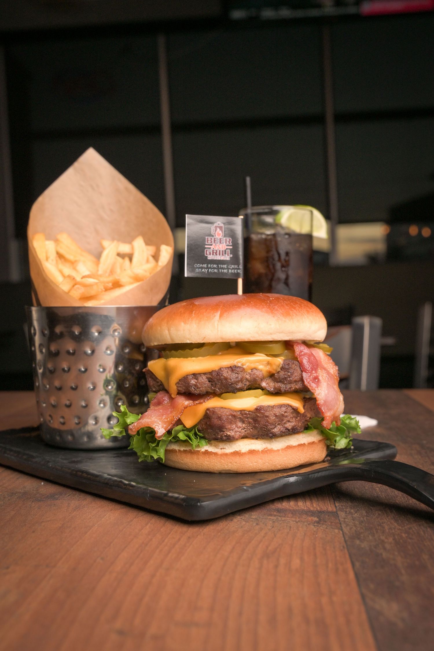 Juicy cheeseburger with lettuce on a wooden table.