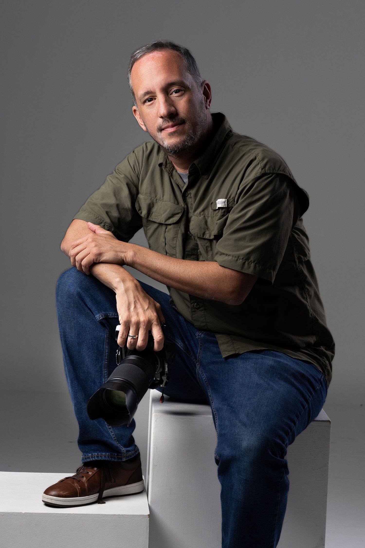 Professional studio portrait poses against grey background.