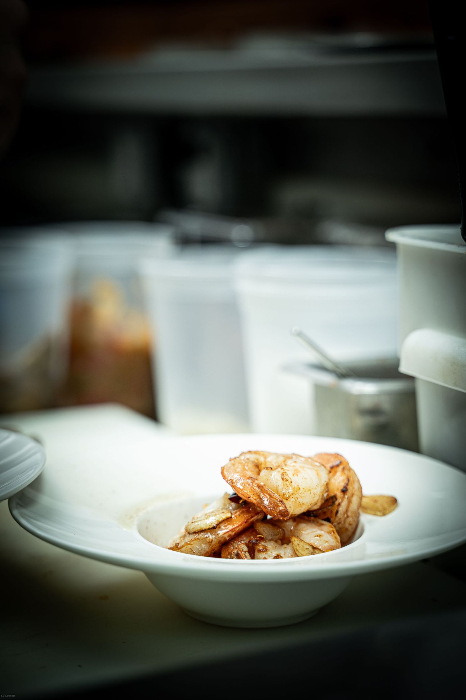 Plated white dish with delicate food presentation shown in progressive serving steps.