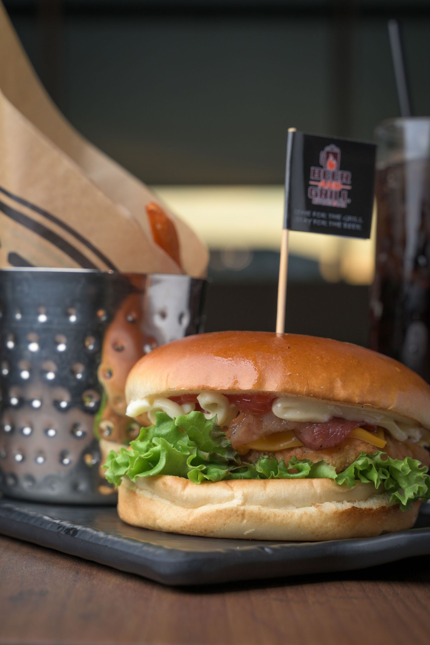 Classic submarine sandwich with lettuce on a soft roll served on dark plate.