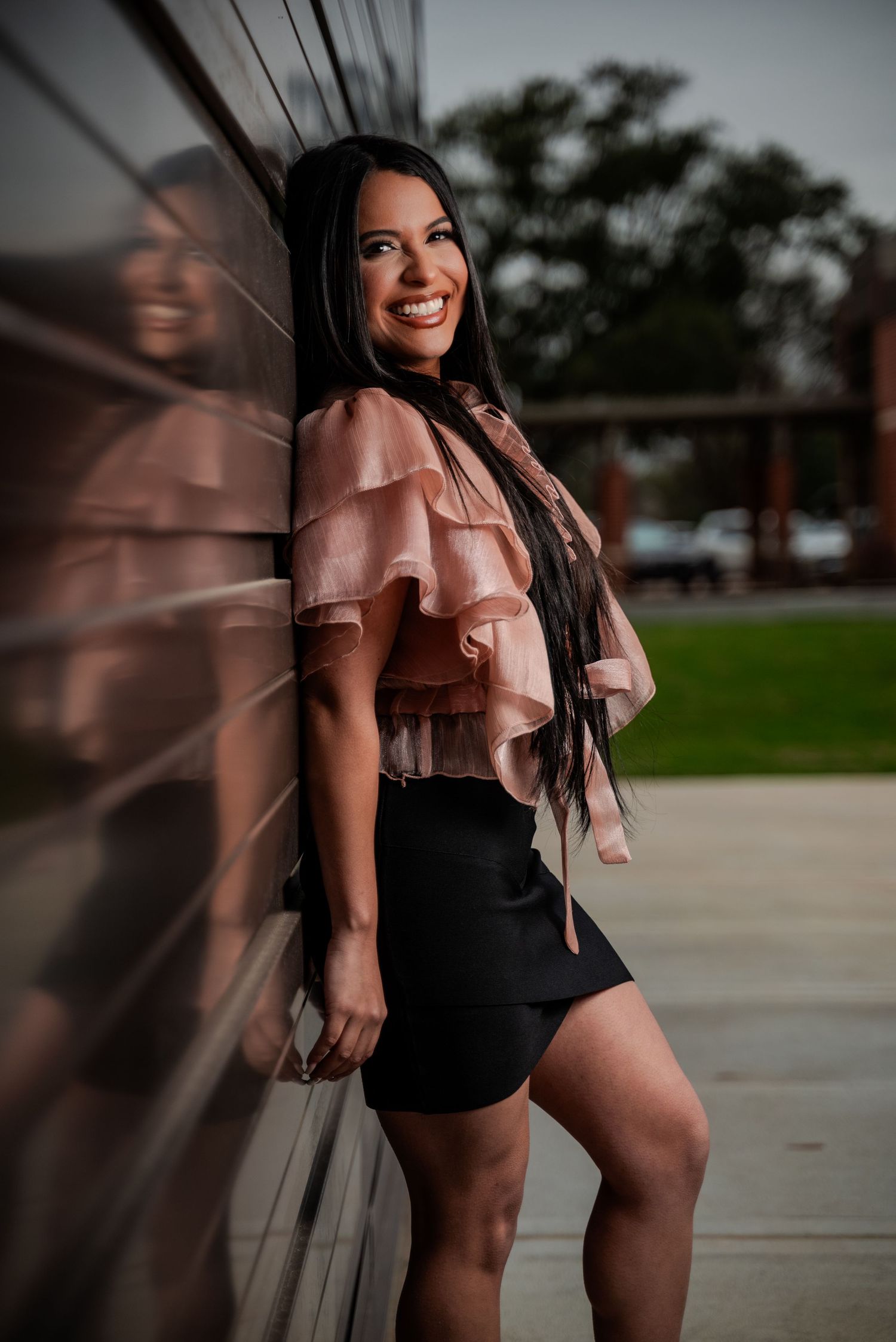 Fashion model posing in Old Town Katy, Texas, wearing a stylish outfit in a charming urban setting.