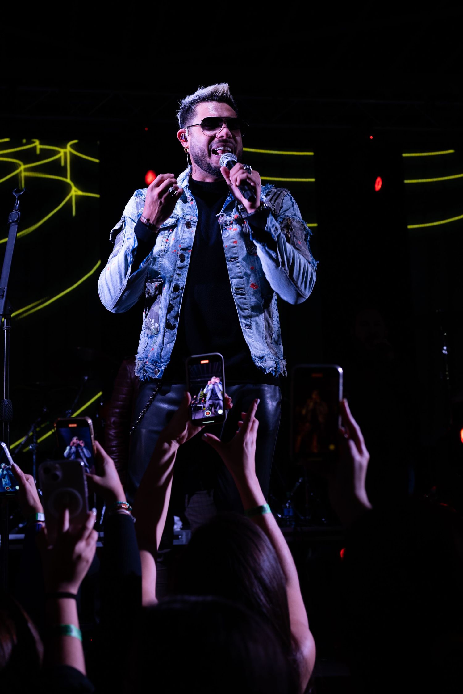 Live music concert in Houston with stage lighting and visible crowd.