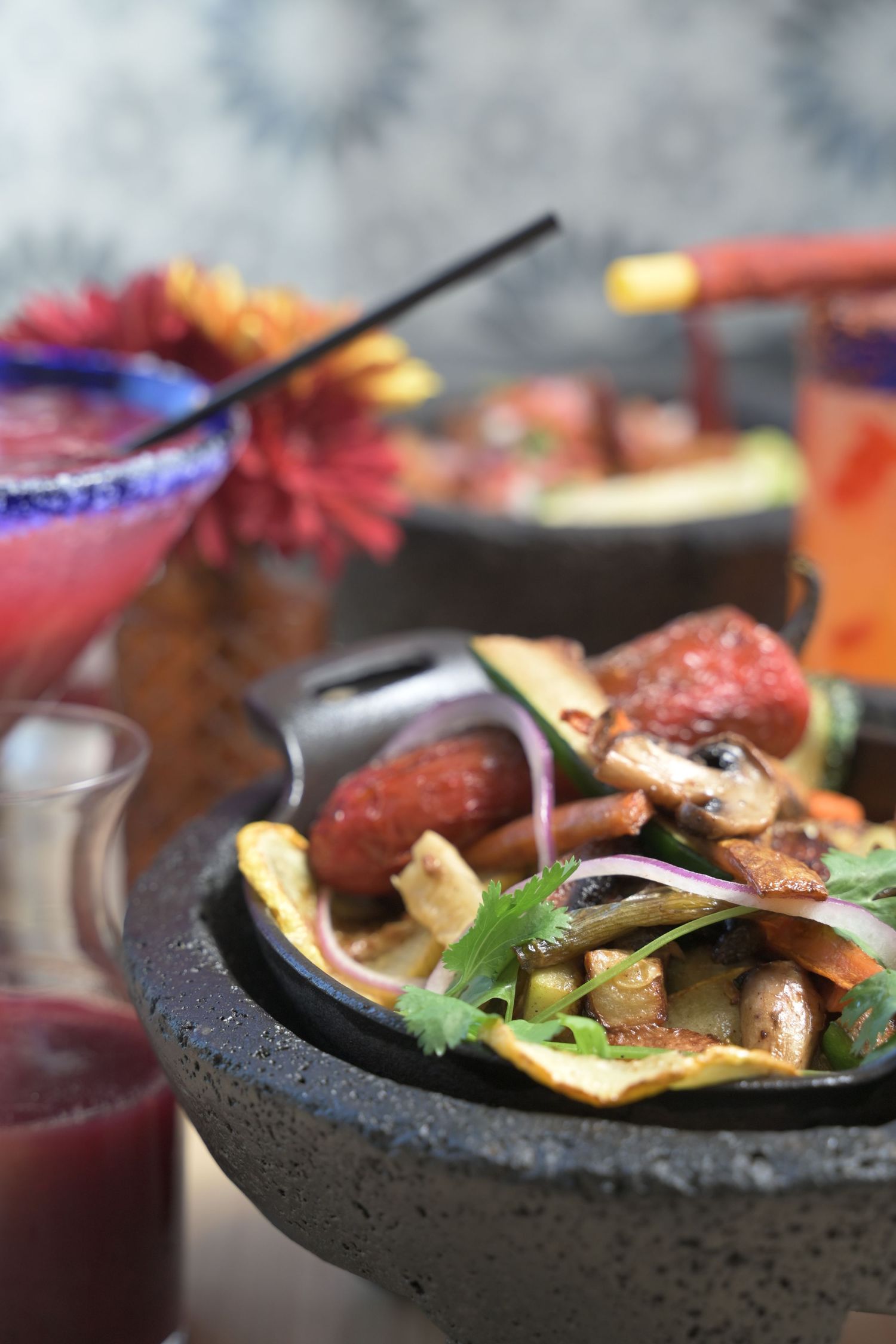 Sizzling fajitas with meat and vegetables served on a hot cast iron skillet.