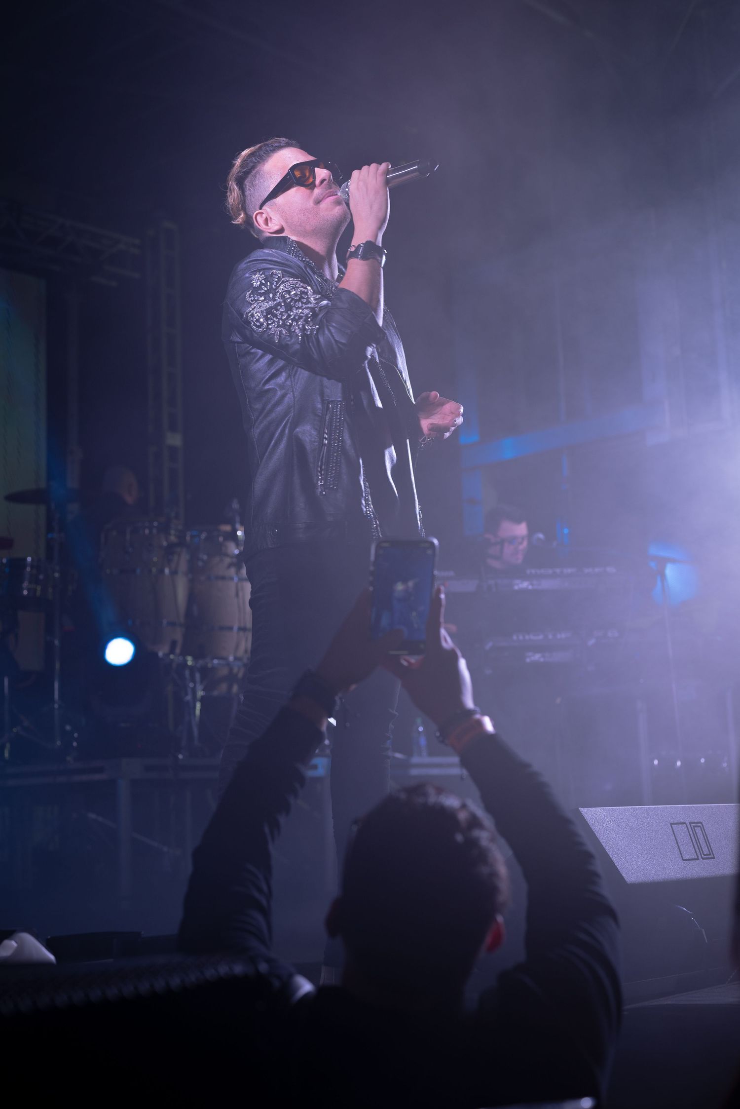 Live music concert in Houston with stage lighting and visible crowd.