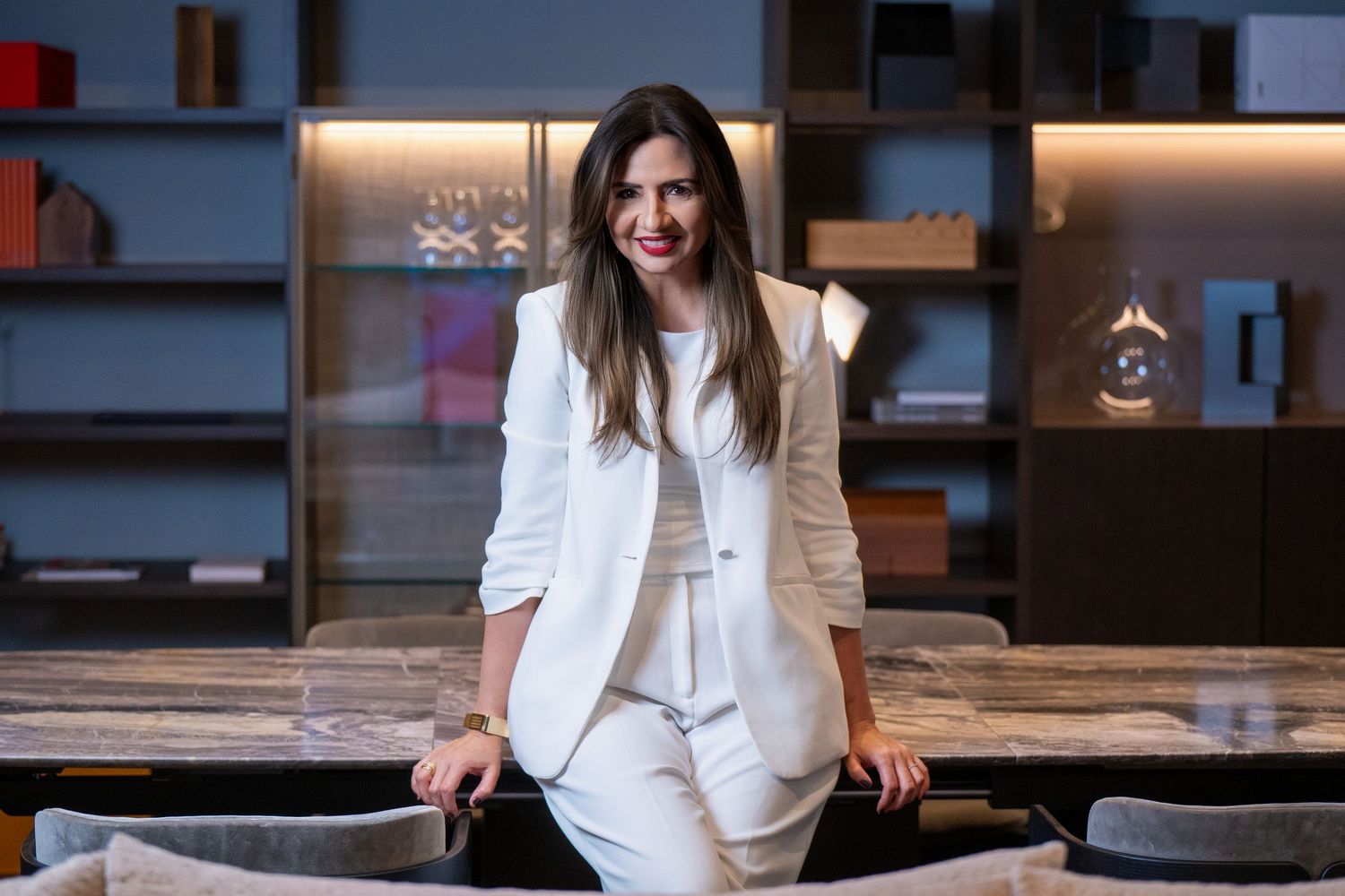 A collection of professional business photos showing a person in white attire in various seated poses and work settings.