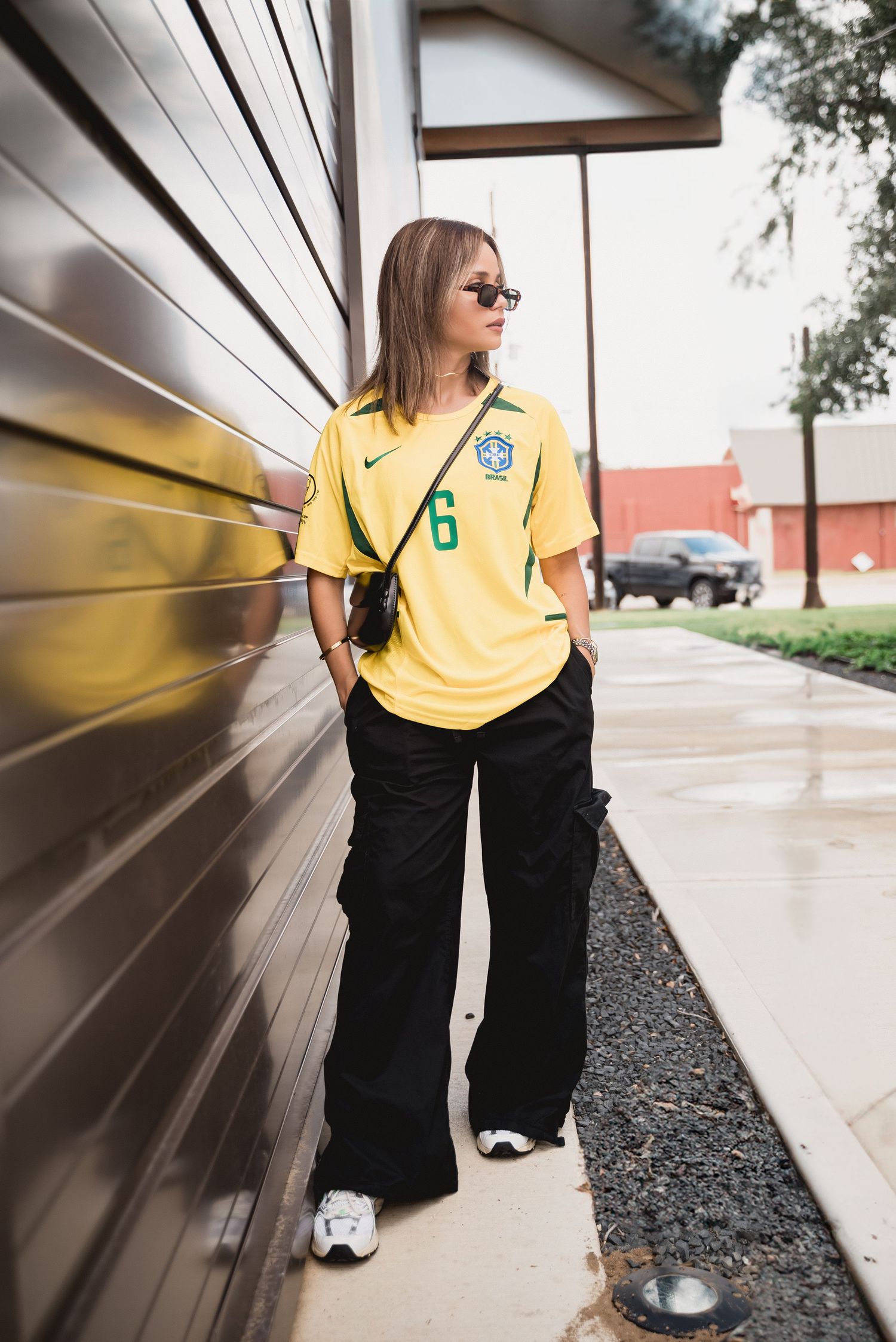 Fashion model posing for a custom football jersey brand in Houston, Texas. Branding photo showcasing athletic streetwear style, ideal for sp
