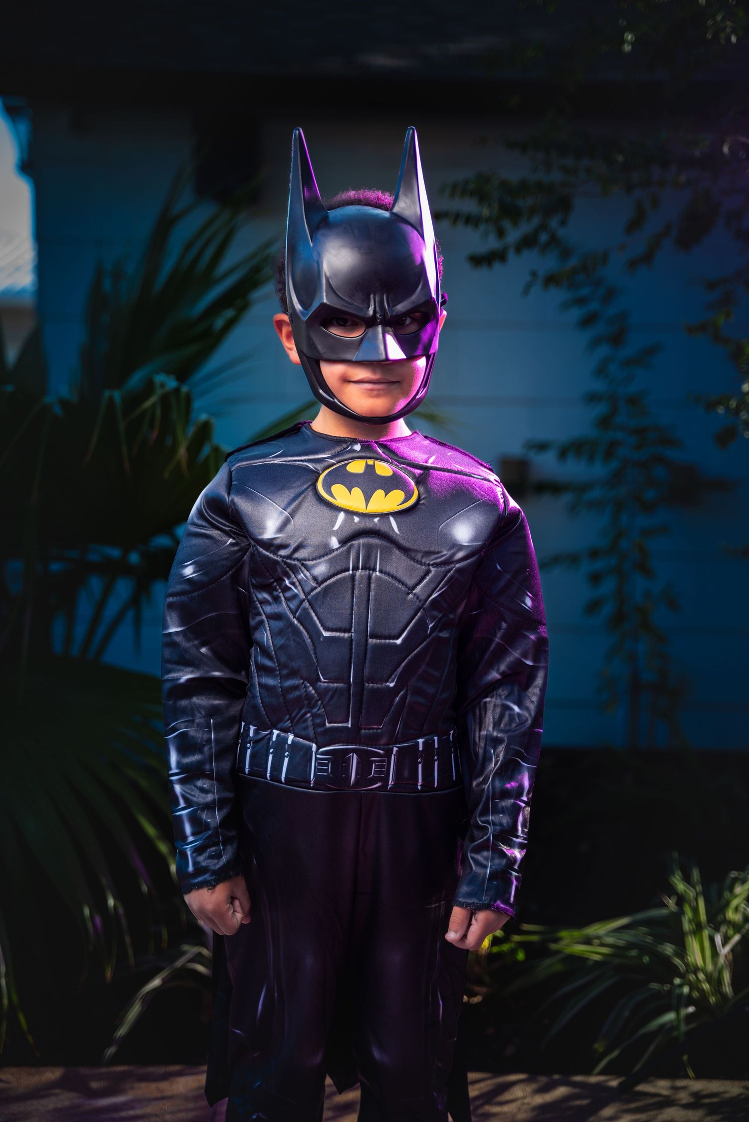 Halloween portrait of a child dressed as Batman, captured with dramatic artificial lighting in Houston, Texas. Powerful visual perfect for t