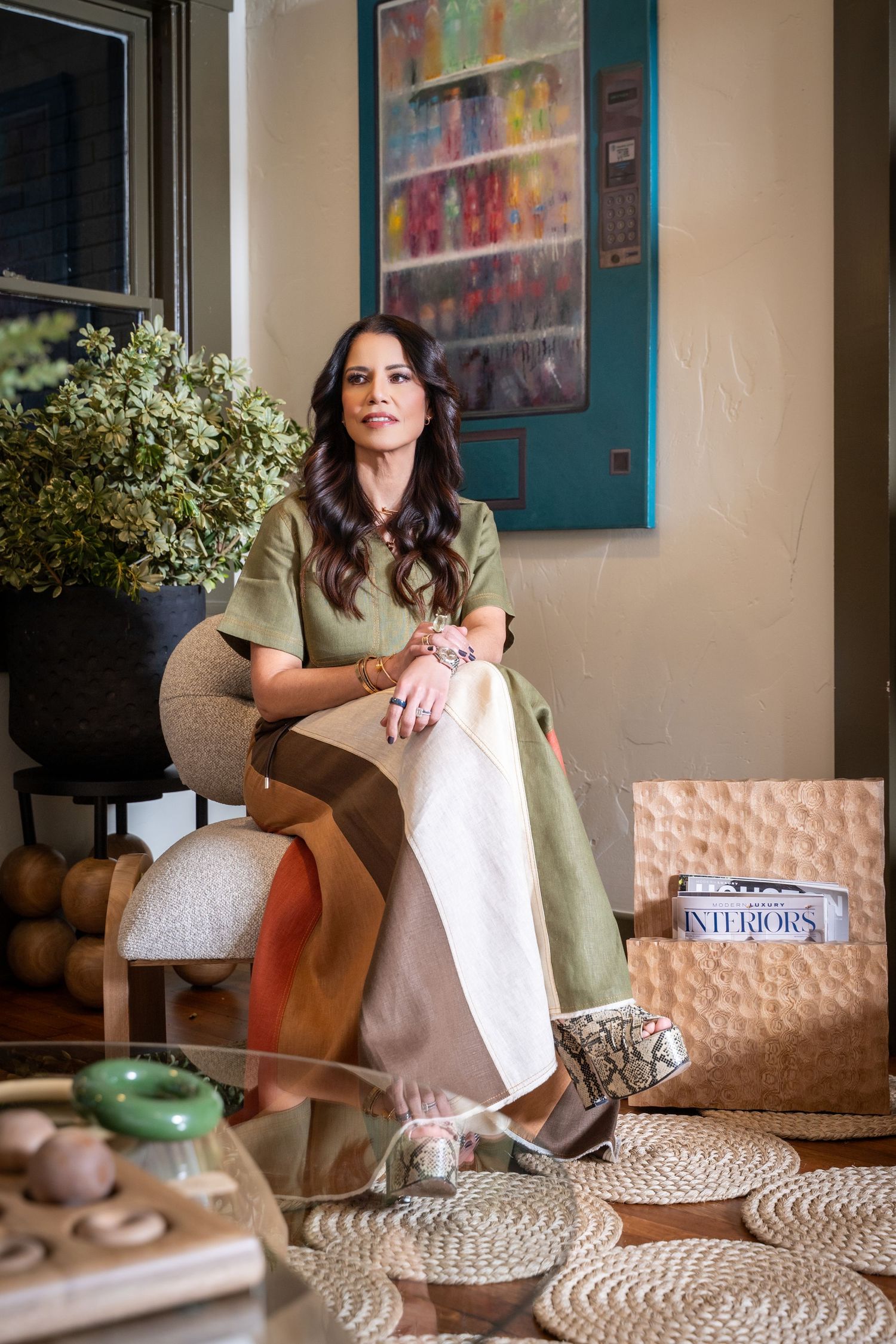 A series of connected photos showing someone sitting on a pink couch with decorative elements and artwork in the background.