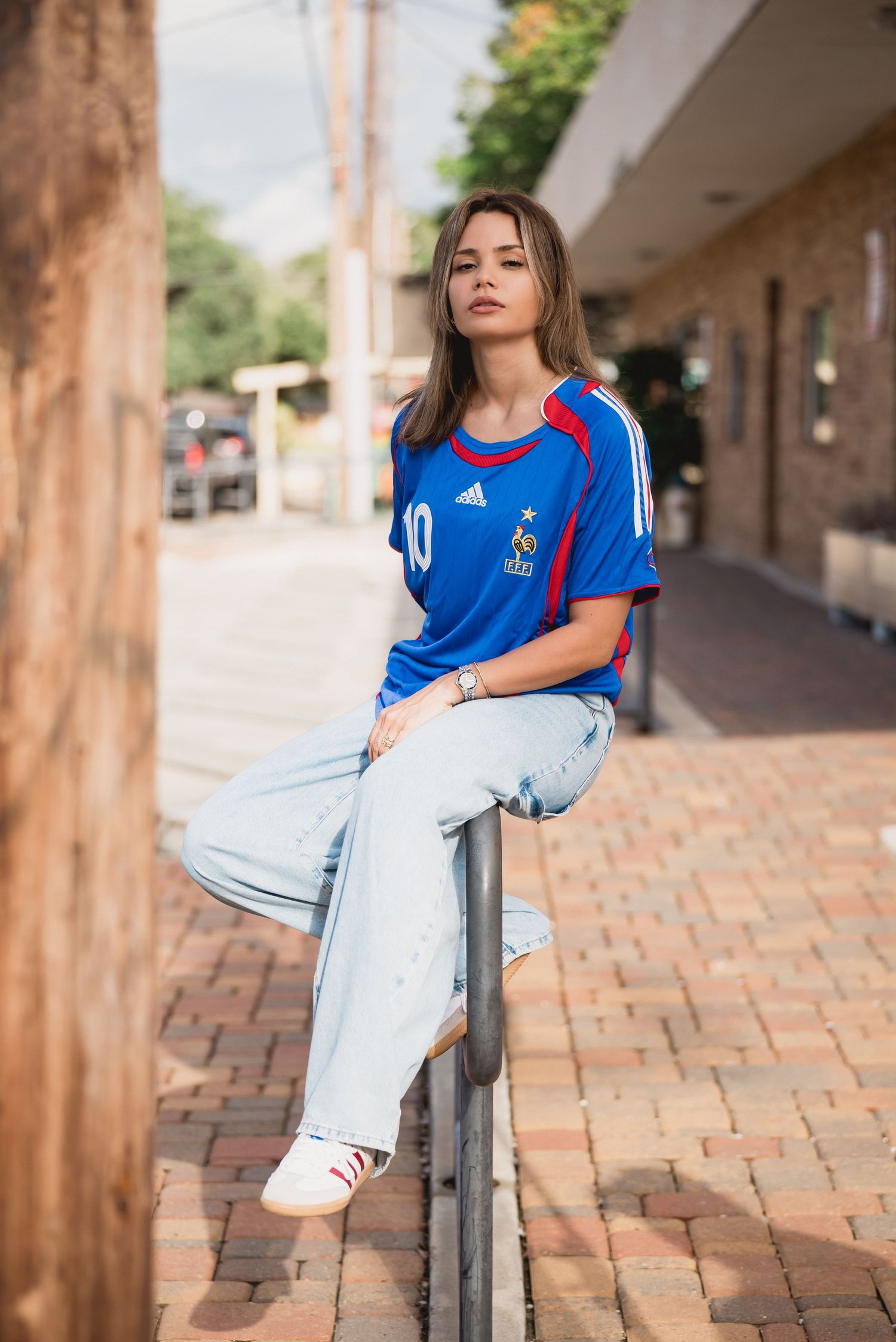Fashion model posing for a custom football jersey brand in Houston, Texas. Branding photo showcasing athletic streetwear style, ideal for sp
