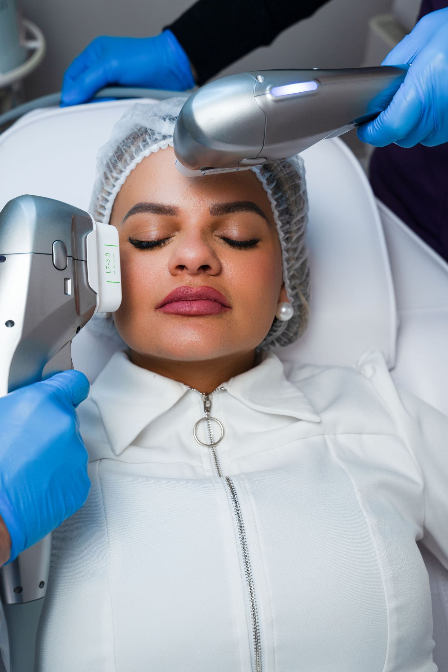 Patient receiving professional skin treatment with advanced laser technology in medical spa setting.