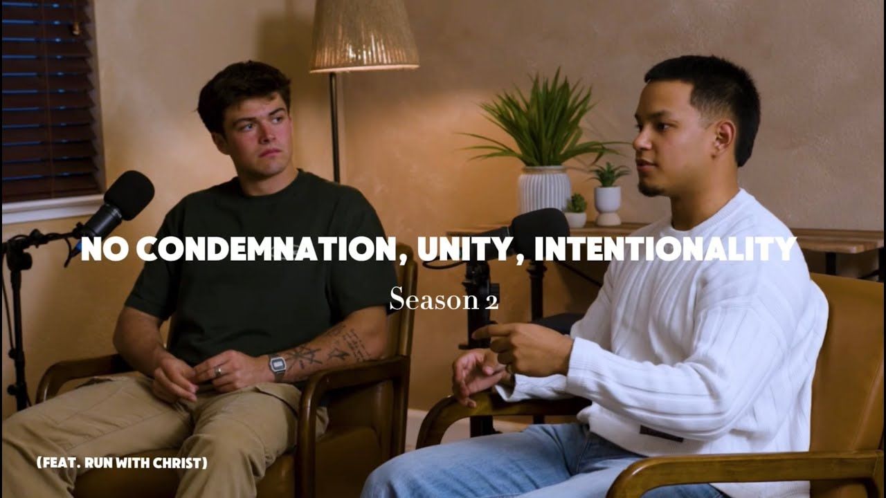 Two people sit having a conversation in front of microphones with text overlay reading 